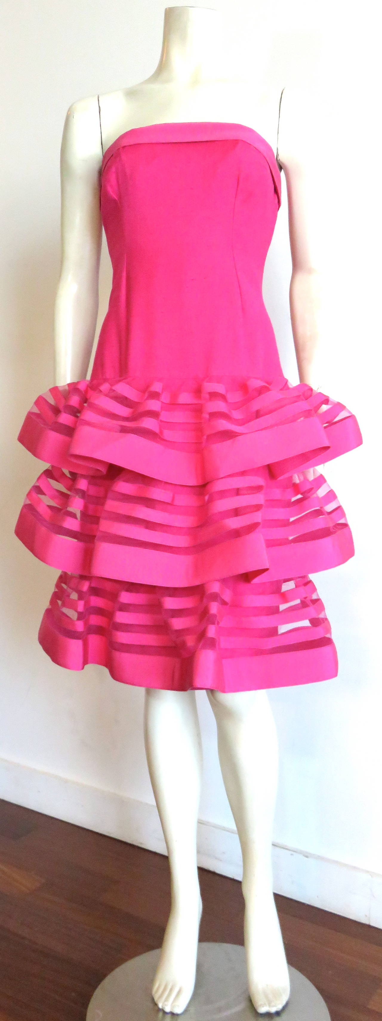 Late 1970's, NINA RICCI PARIS hot pink, tiered party dress.

The base of the dress is made of natural, Shantung-style, silk/woolen base fabric.  The triple bottom tiers are made of matching, sheer, mesh netting with solid, grosgrain ribbon