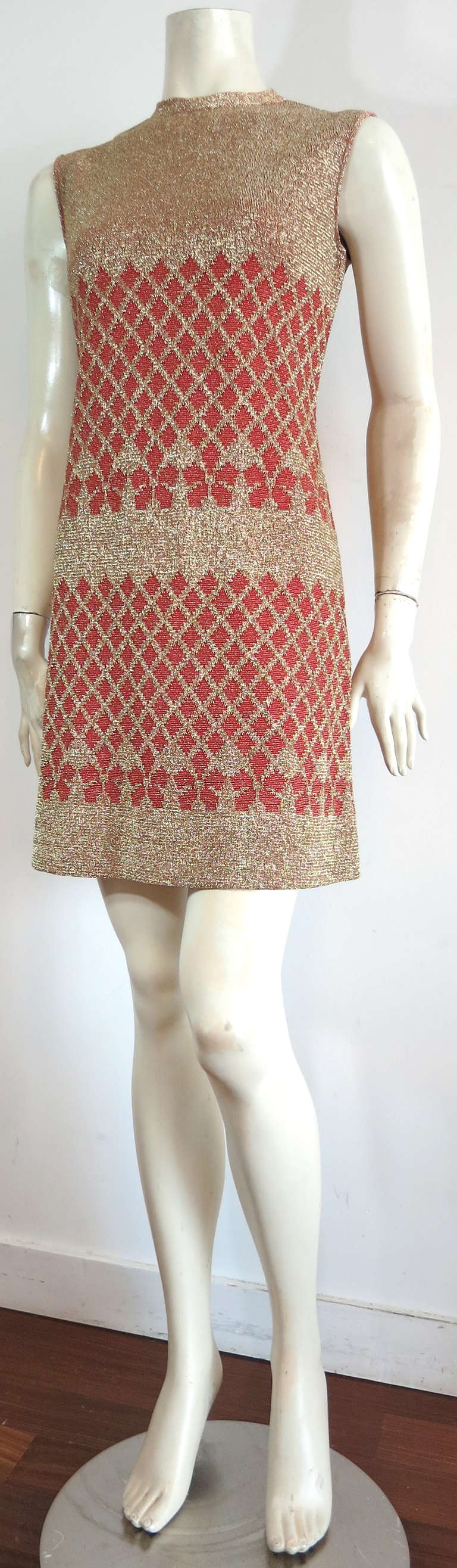 Mint condition PIERRE BALMAIN PARIS Les Tricots knit dress.

This stunning dress was designed by Pierre Balmain in France during the 1960's.

The tricot knit dress features gorgeous, engineered lattice, bow style artwork with metallic gold &