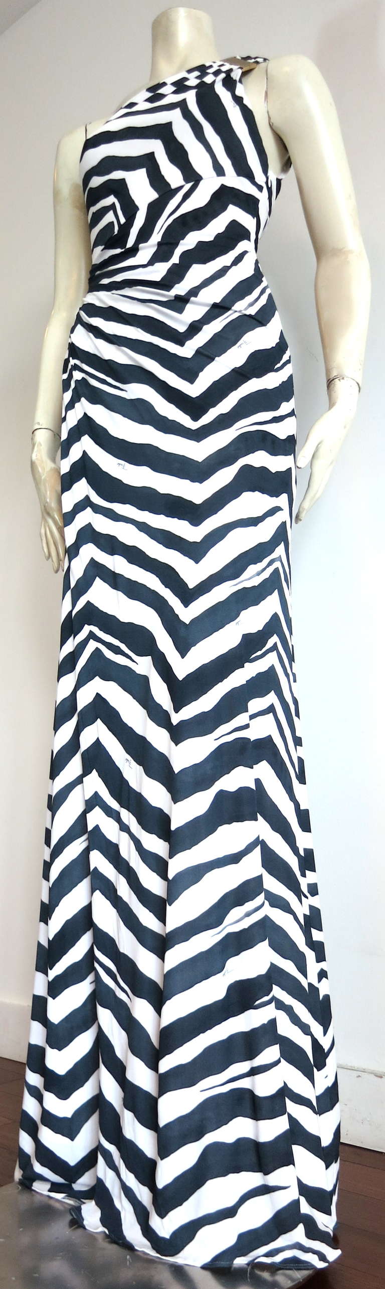 Gorgeous EMILIO PUCCI signed zebra print dress.

This recent dress from Emilio Pucci is made of printed silky, viscose knit jersey, and features a logo engraved, gold-finished metal, square hardware detail at the wearer's left