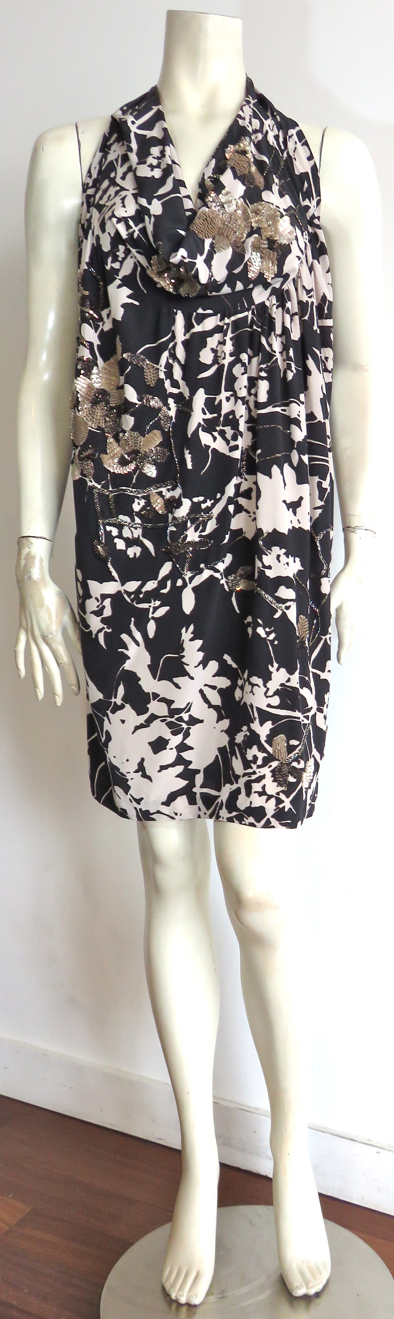 Never worn, DRIES VAN NOTEN, embellished silk floral print dress.

Stunning, two-tone style, floral printed artwork in black and white with gray outlines.  

The dress is gorgeously embellished with matte-golden, as well as deep bronze sequins,