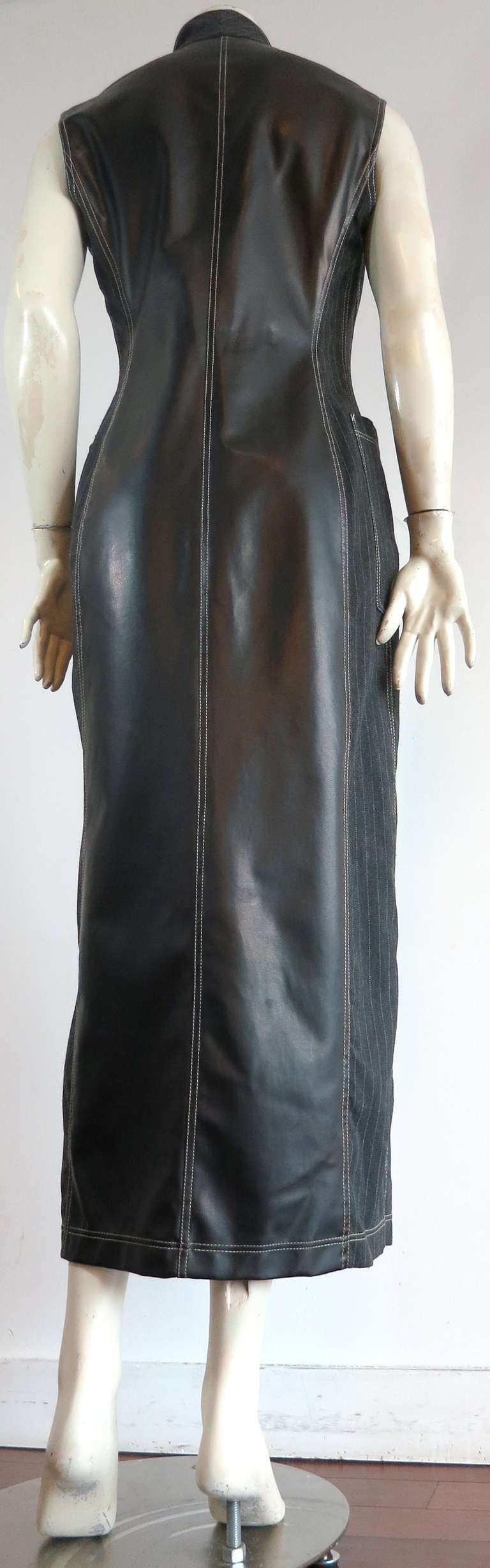 1980's GAULTIER Pinstripe coat dress with PVC/Pleather back panel.

This amazing tailored coat dress was designed by Jean-Paul Gaultier under his early line, Junior Gaultier manufactured by Gibo, and was made in Italy during the 1980's.

The