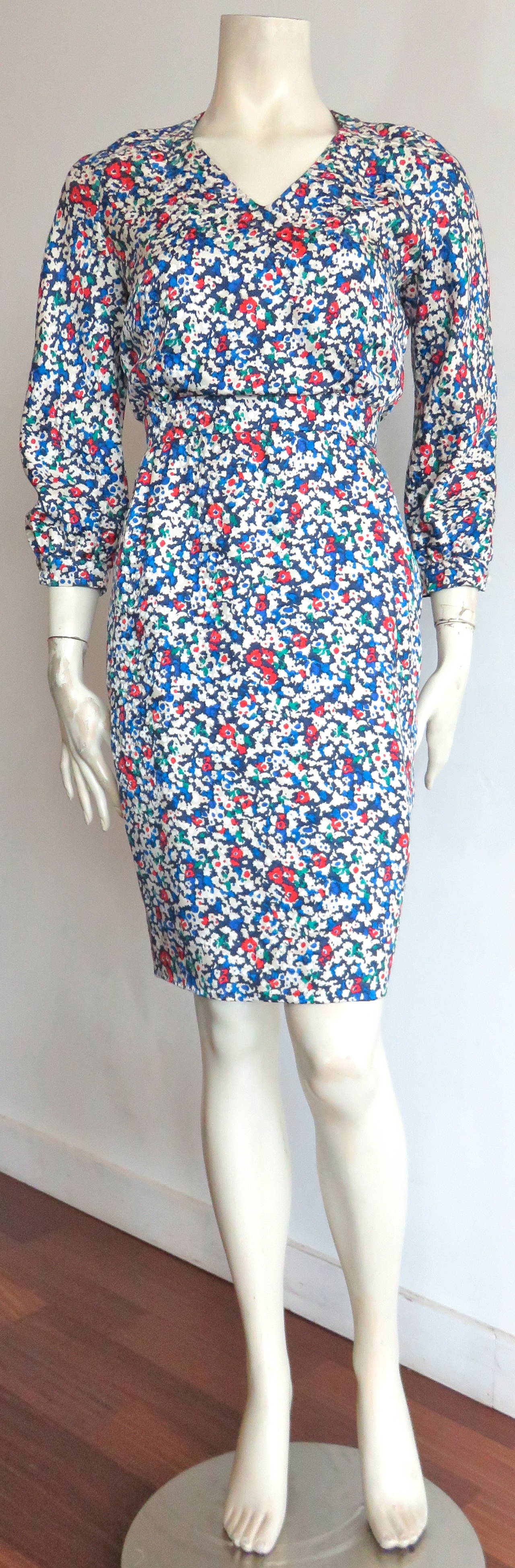 Mint condition, 1980's VALENTINO Silk floral day dress.

Gorgeous, multi-color floral print atop dotted floral silk fabric.

3/4-length, raglan sleeves with large, faux-pearl button closures at cuffs.

'V'-shaped neckline front with concealed,