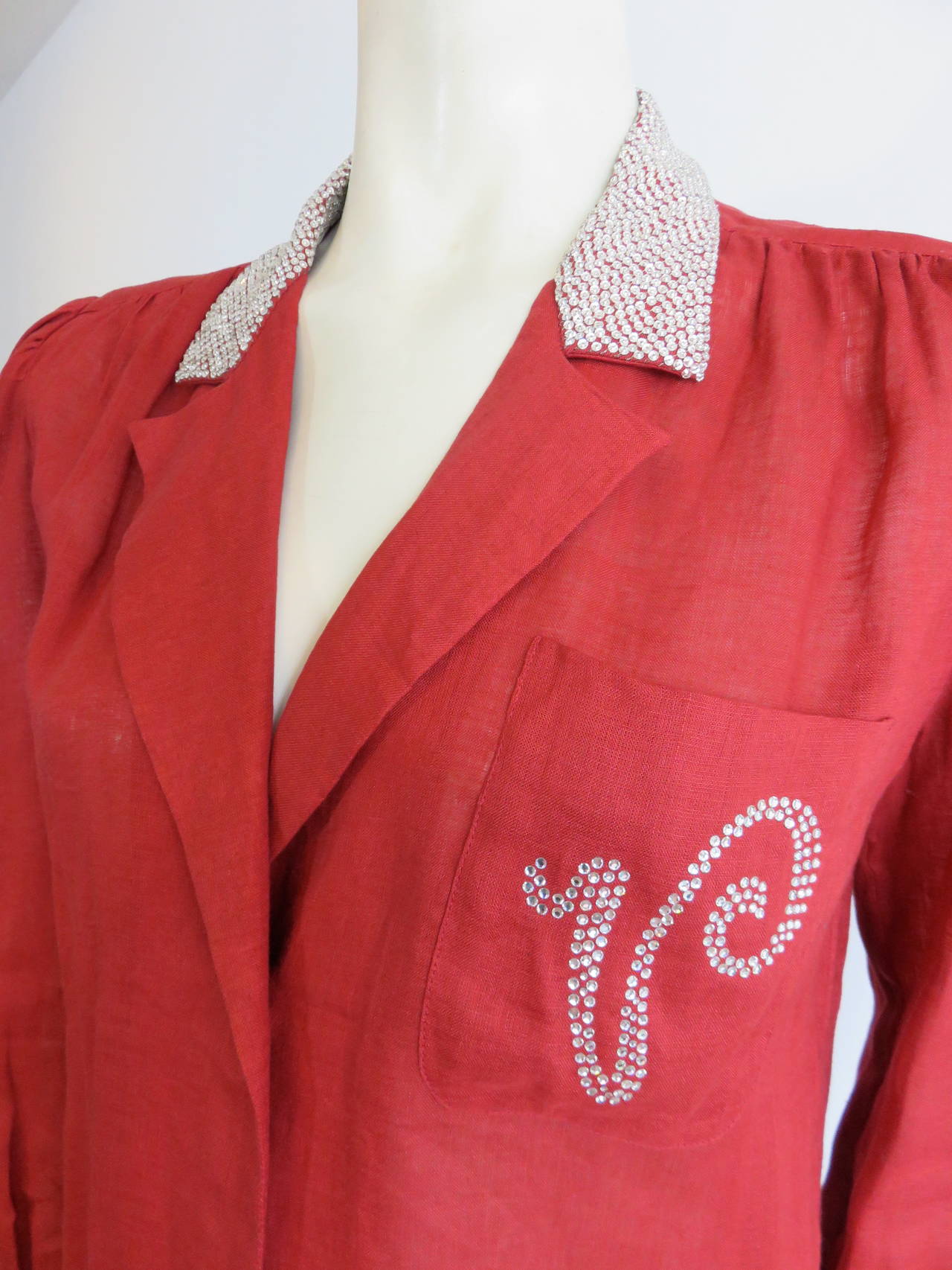 Excellent condition, 1980's VALENTINO Crystal 'V' monogram red linen shirt.

This fabulous shirt features all-over, mini crystal-head embellishments at the top collar with rhinestone 'V' monogram at the left chest.

Valentino red, linen