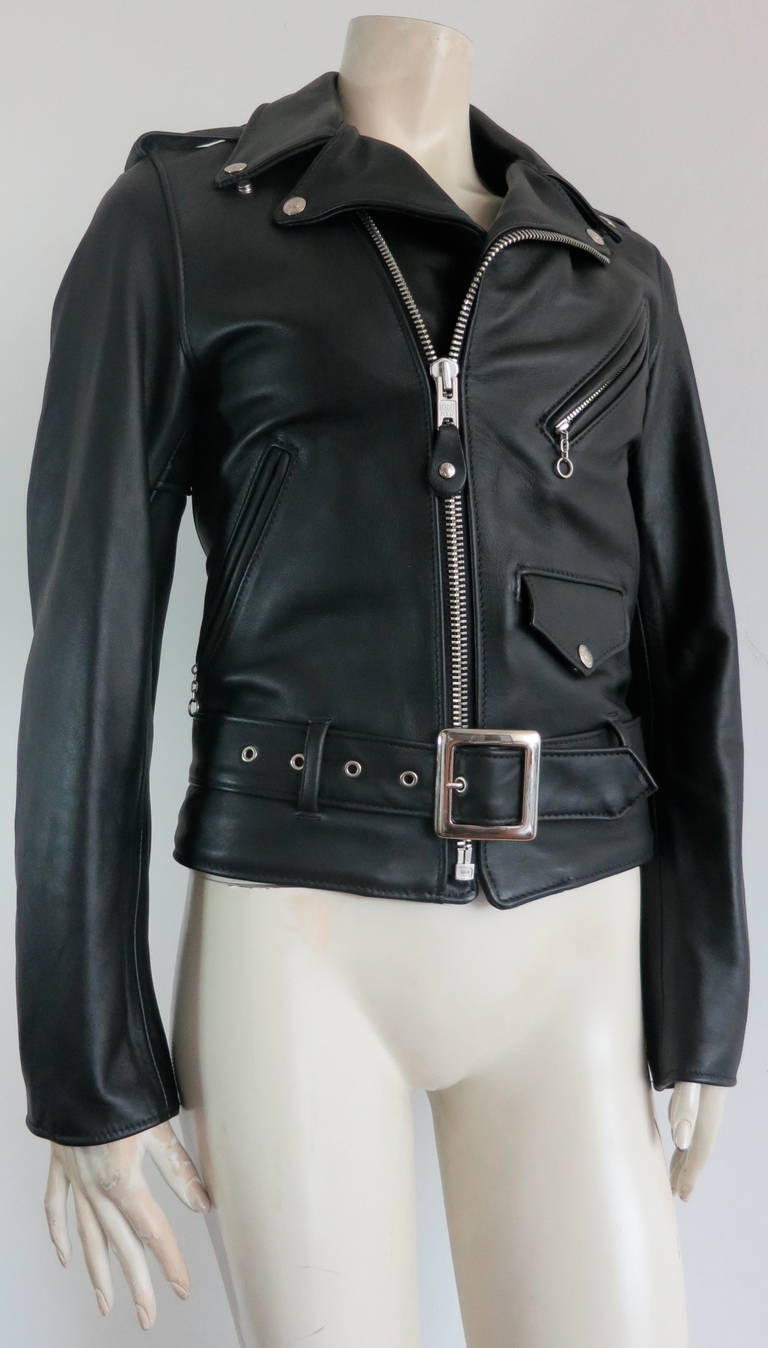 Unworn SCHOTT Perfecto women's leather motorcycle jacket.

Black leather skin with logo engraved metal zippers and hardwares.

Adjustable waist belt with adjustable buckle hardware.

Made in the USA, as labeled.

New, unworn with no flaws or