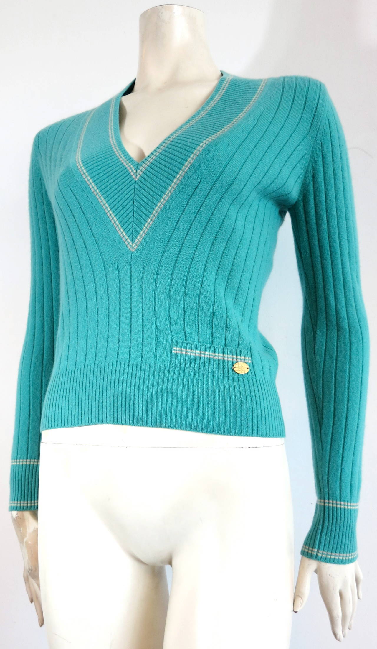 Excellent condition, CHANEL PARIS pure cashmere, 'V'-neck, tennis sweater in refreshing mint green color.

Luxuriously soft hand-feel.  

Small pocket detail opening at wearer's left waist with 'CC' logo engraved oval metal plate.

Striped