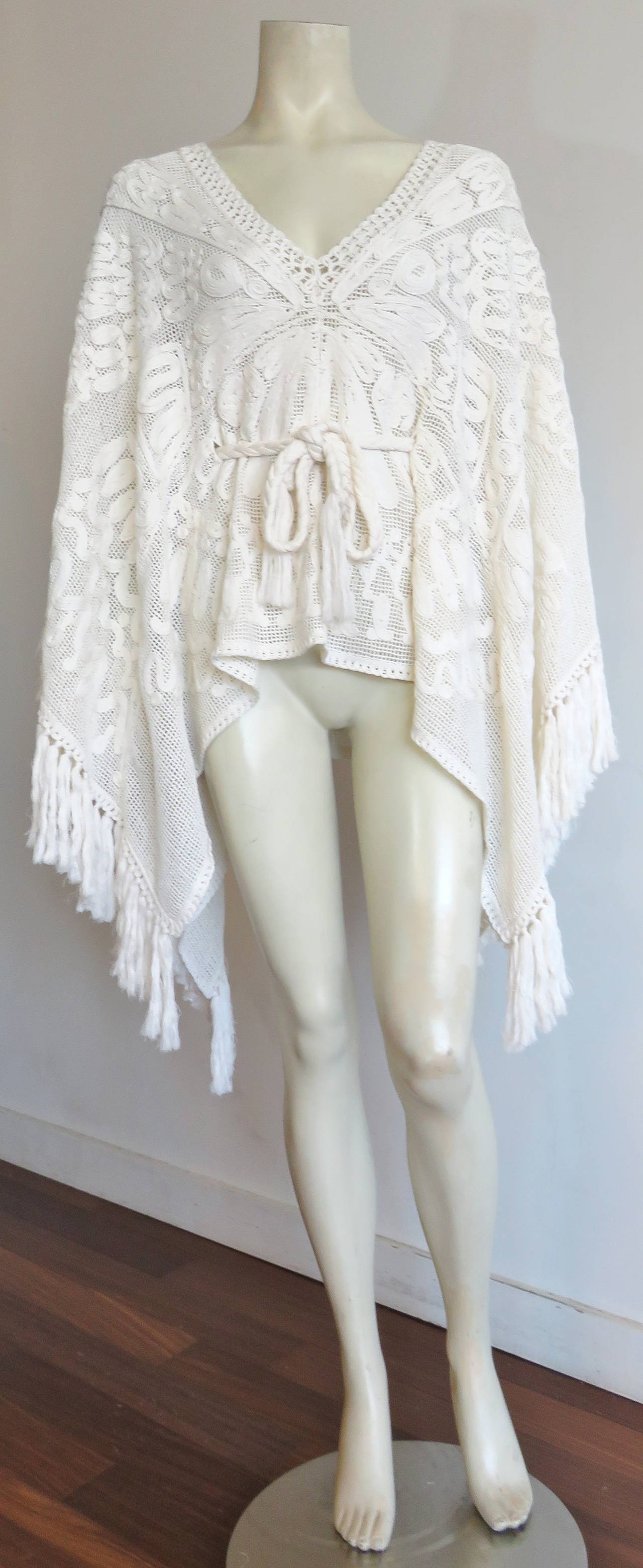 New, EMILIO PUCCI, soutache crochet fringe poncho with adjustable braided waist tie/belt.

Fabulous, open crochet knit ground with amazing soutache spiral motifs arranged in a circular, radial design at front and back.

Spiral braid trimmings