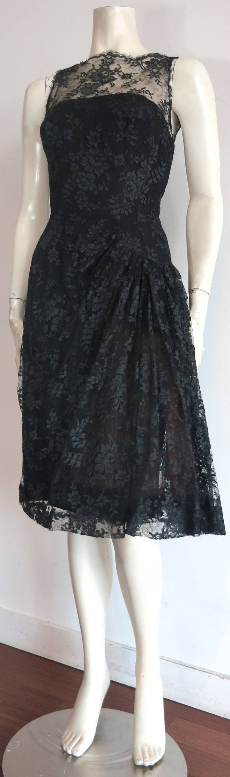 Stunning, LUIS ESTEVEZ Chantilly lace cocktail dress.

This lovely dress was designed by Luis Estevez during the 1960's in the USA, and is union labeled.

The black, Chantilly lace is very detailed with beautiful florals in the foreground, and