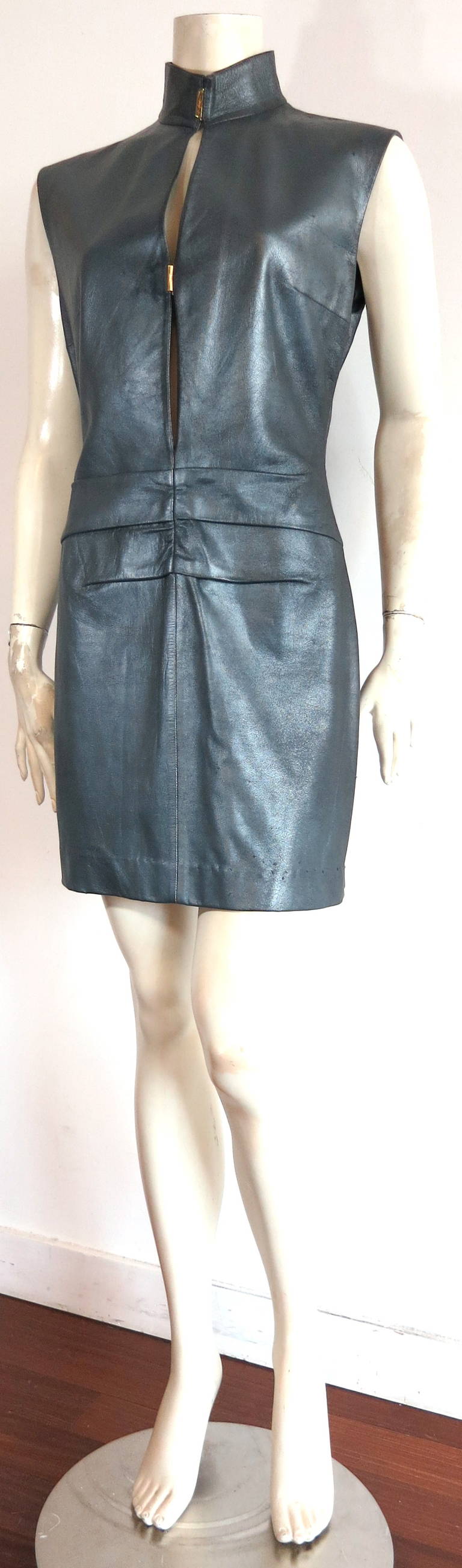 1990s YVES SAINT LAURENT Gunmetal leather dress.

This amazing, all leather dress features a gorgeous gunmetal-metallic, shimmer finish.

Twin, polished gold finished, 'YSL' logo engraved metal closures at center front.

Box pleated
