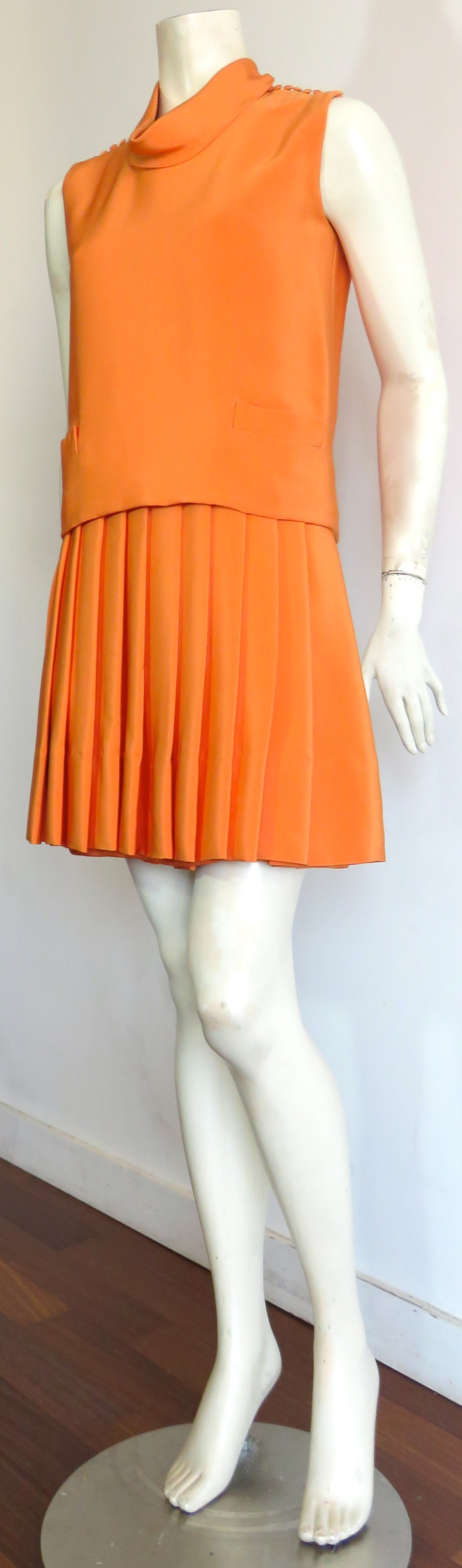 Very chic, 1960's, NORMAN NORELL 2pc. silk, knife-pleat dress set.

Acquired from the original owner, and in excellent condition with no damages.

Beautifully constructed set consisting of knife-pleated, silk under dress, and top bodice with