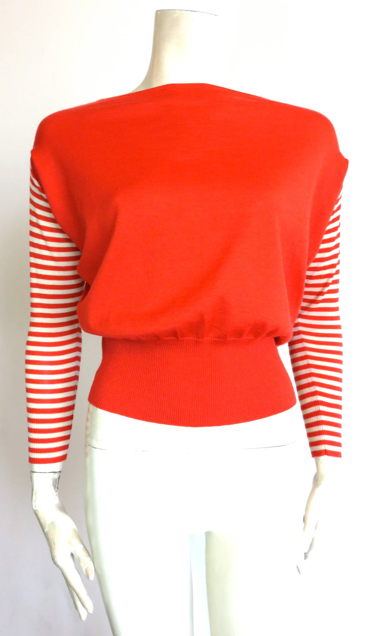 Never worn, HERMES PARIS by Martin Margiela cashmere & silk, knit sweater.

Luxuriously soft, light-weight hand-feel.

Boat-neckline opening with dropped shoulder, and fitted waist silhouette.

Signature Hermes orange color with novelty,