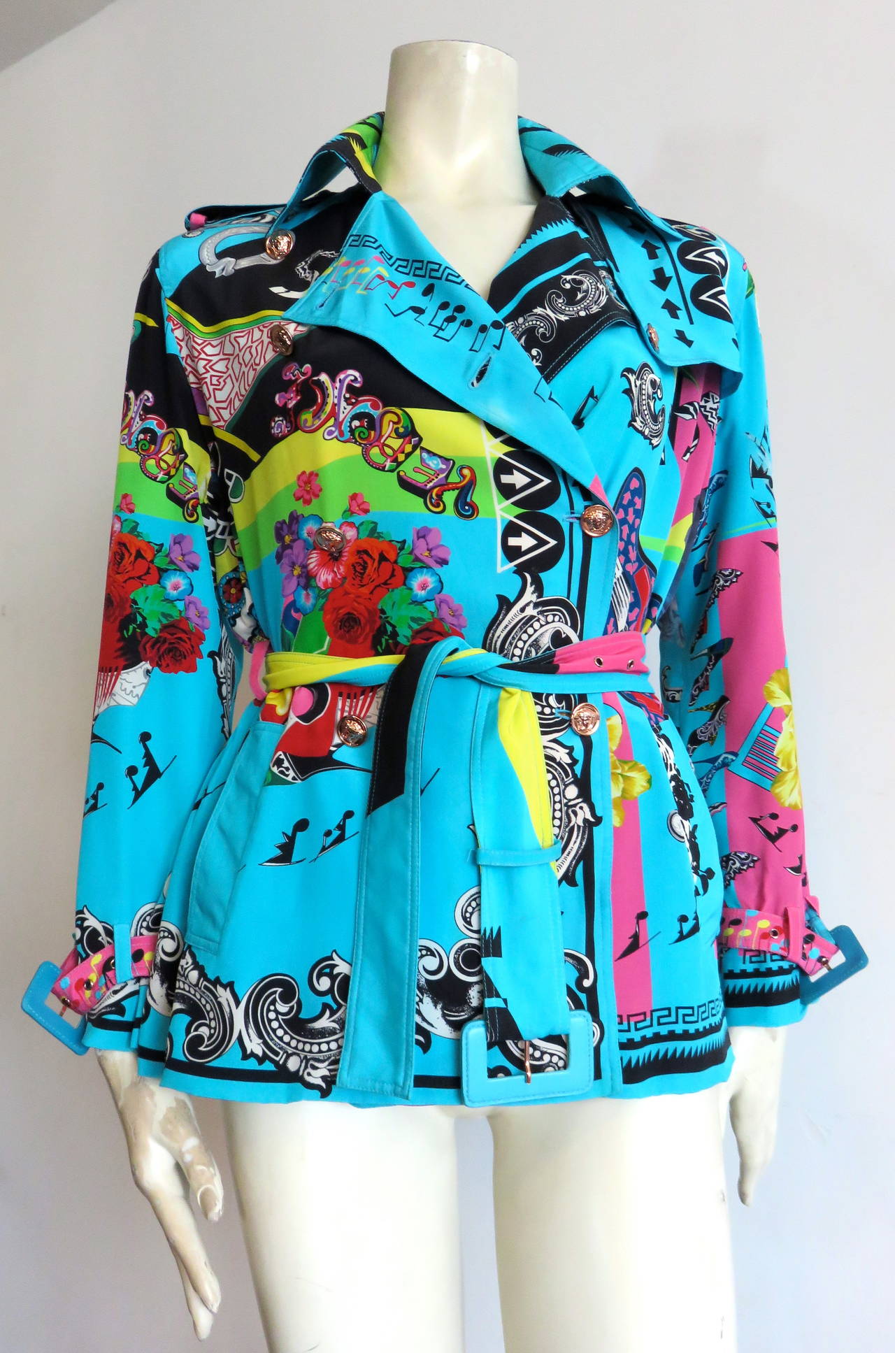 Recent VERSACE 'Music Print', pure silk, belted jacket.

Fabulous, muti-color Versace print featuring music-themed motifs, and floral artworks.  

Light-weight, trench jacket silhouette with belted waist, and cuffs.  Shoulder epaulets. 