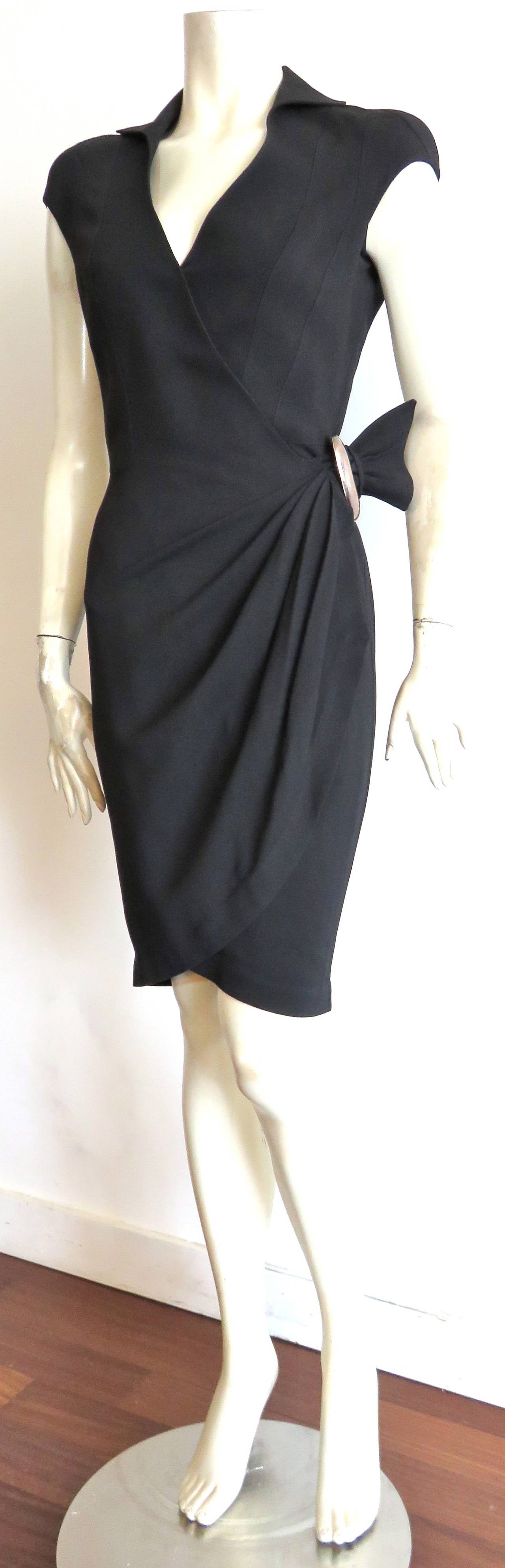 Great condition, THIERRY MUGLER PARIS, 1980's black crepe wrap dress with polished pewter hardware buckle detail. 

Wrapped waist construction with adjustable belted hardware at wearer's left side hip, and pleated construction. 

Ergonomic