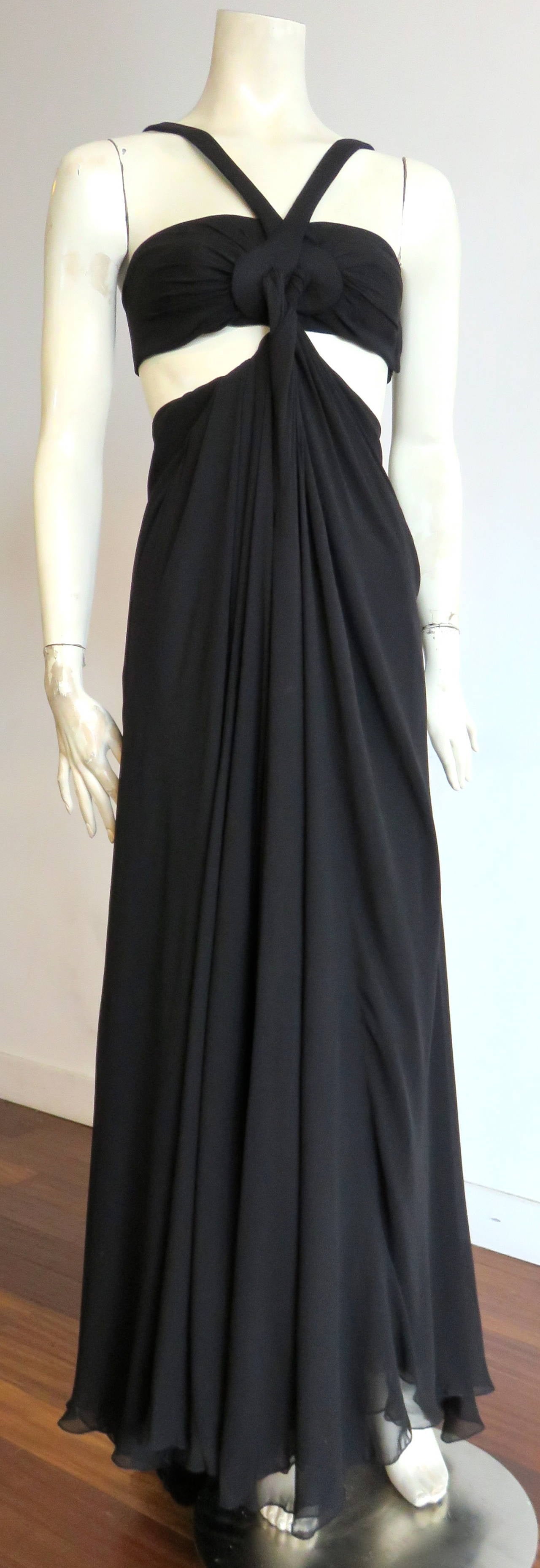 Never worn, and still with original tags, GUCCI by Tom Ford, black silk, twisted drape cut-out dress.

This stunning dress features a gorgeous, bandeau style top with V-neck straps.  The neck straps circulate at the front bust, with silk chiffon