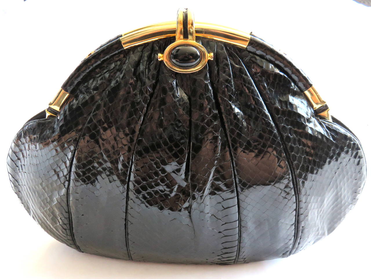Mint condition, 1960's JUDITH LEIBER Black python evening bag.

This flawless, evening bag looks to have never been used, and is in pristine condition with absolutely no signs of wear or flaws.

Slick, glossy black python skin with metal top
