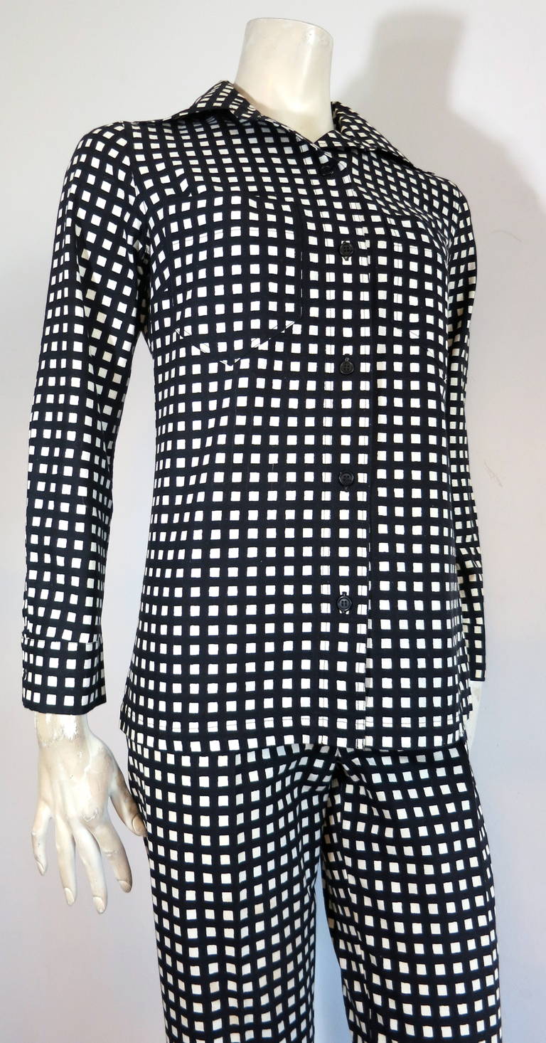Mint condition 1973 MARIMEKKO OY FINLAND Black & white shirt & pant set.

Made in Finland, in 1973, as labeled.

Grid print artwork atop cotton fabrication.

Twin chest pockets with black button front closures at front placket & cuffs.

The