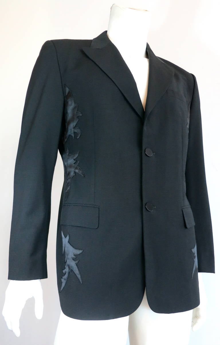 1990's GIANNI VERSACE COUTURE Men's satin applique tuxedo jacket.

Black wool tuxedo/dinner jacket with silk satin embroidered appliqués at sides.

Peak lapel front with two, dating face buttons at front opening.

Twin waist level flap