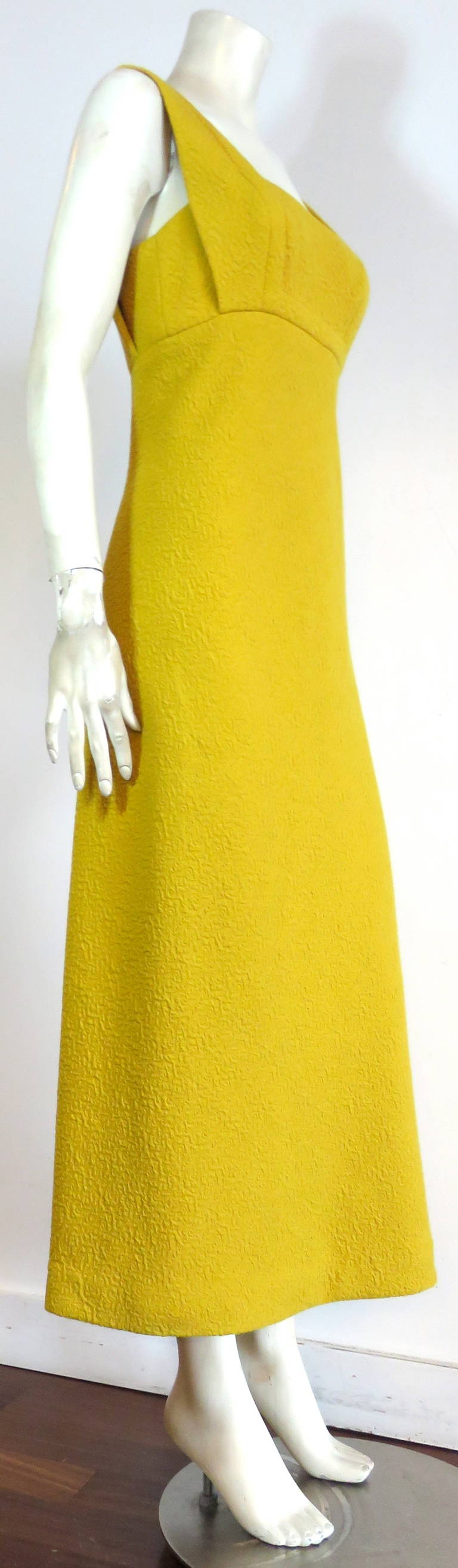 1960's GALANOS yellow, knit crepe empire dress, originally purchased at Amelia Gray, Beverly Hills.

This wonderful knit crepe dress features square cut front and back neckline with single topstitching detailing.   

Concealed side seam zipper