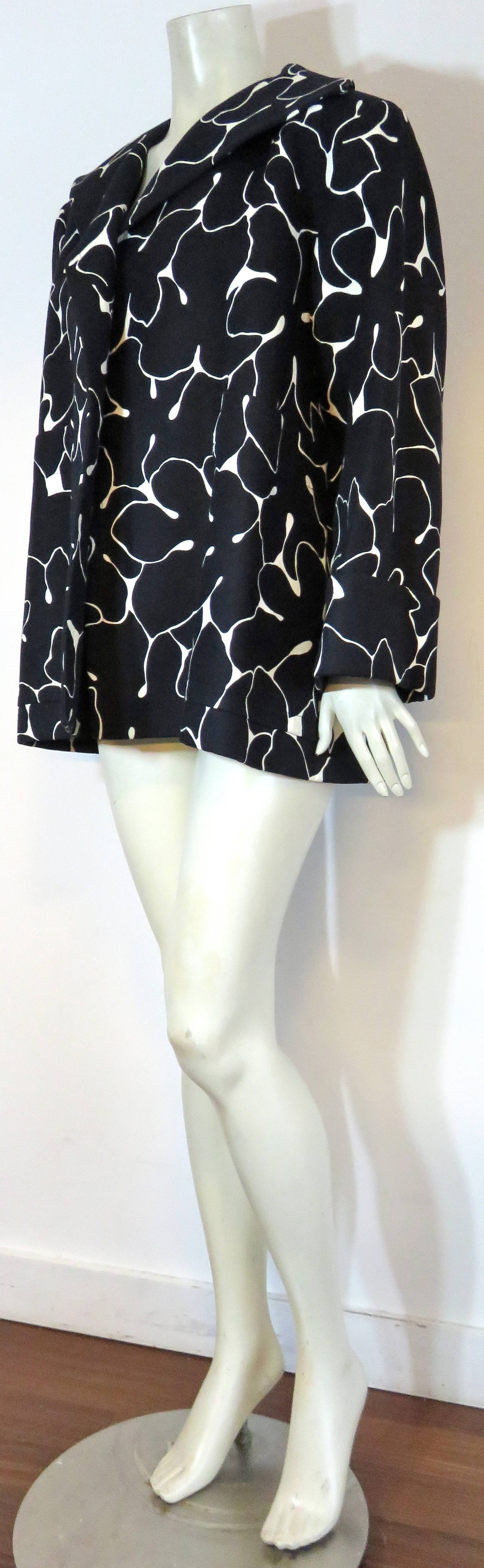Never worn, 1970's YVES SAINT LAURENT Black & white stroller jacket.

This fabulous coat was designed by Yves Saint Laurent during the late 1970's in France.

This coat was never worn, and has a crisp, 'new' appearance with absolutely no
