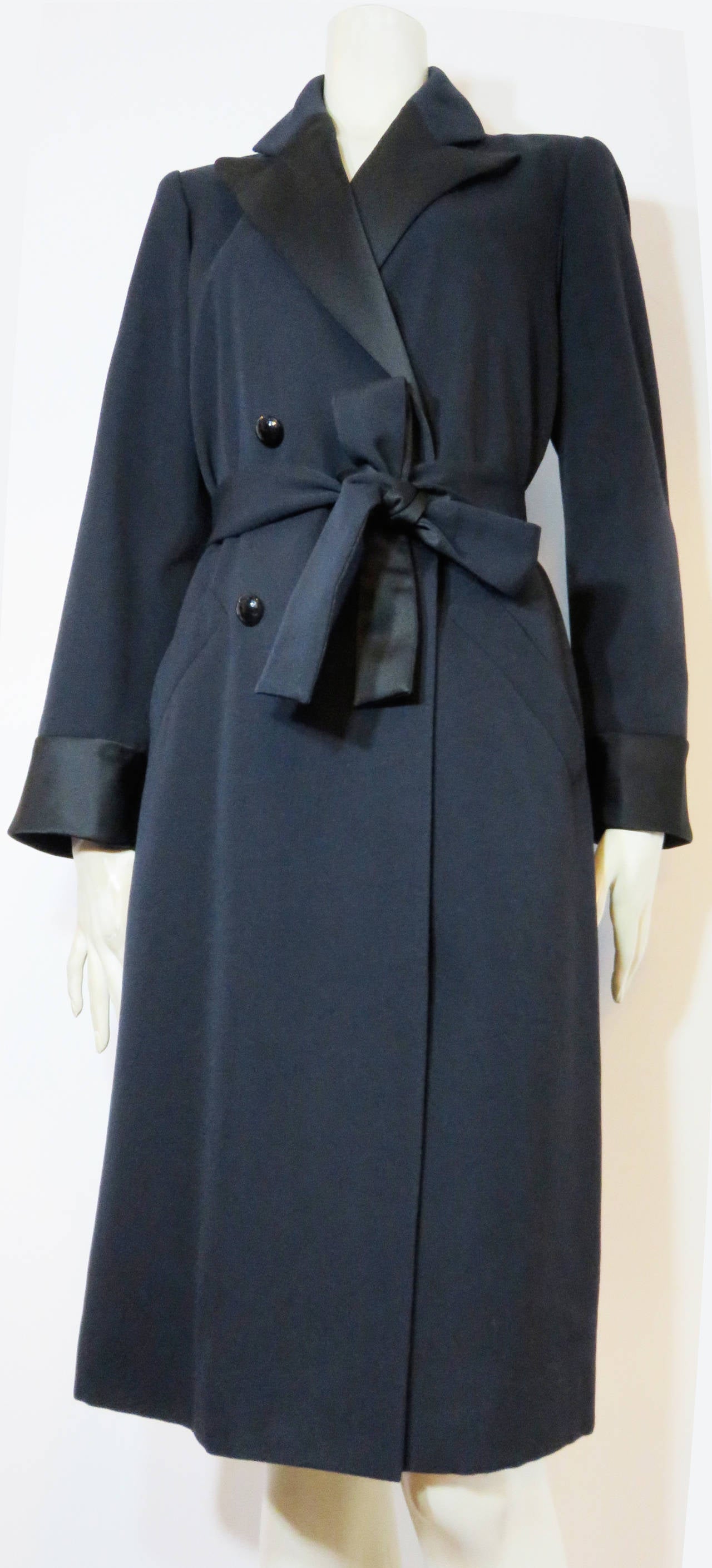 Never worn, 1980's YVES SAINT LAURENT Tuxedo coat dress.

This beautiful coat dress was designed by Yves Saint Laurent during the early 1980's in France.  

The coat dress features luxurious, black silk satin at the front lapels, cuffs, and the