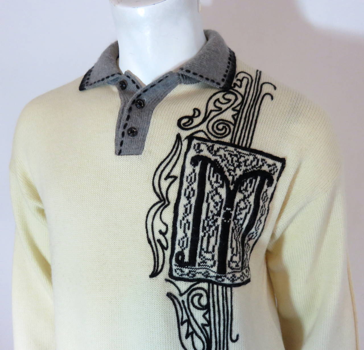 Excellent condition, 1980's MATSUDA JAPAN Men's M. Nicole 'Letterman' sweater.

Light creme/ivory, wool knit fabrication with cross-grain, gray bottom border and cuff edges.

Contrast, black, 1930's inspired motifs at the left chest with framed,