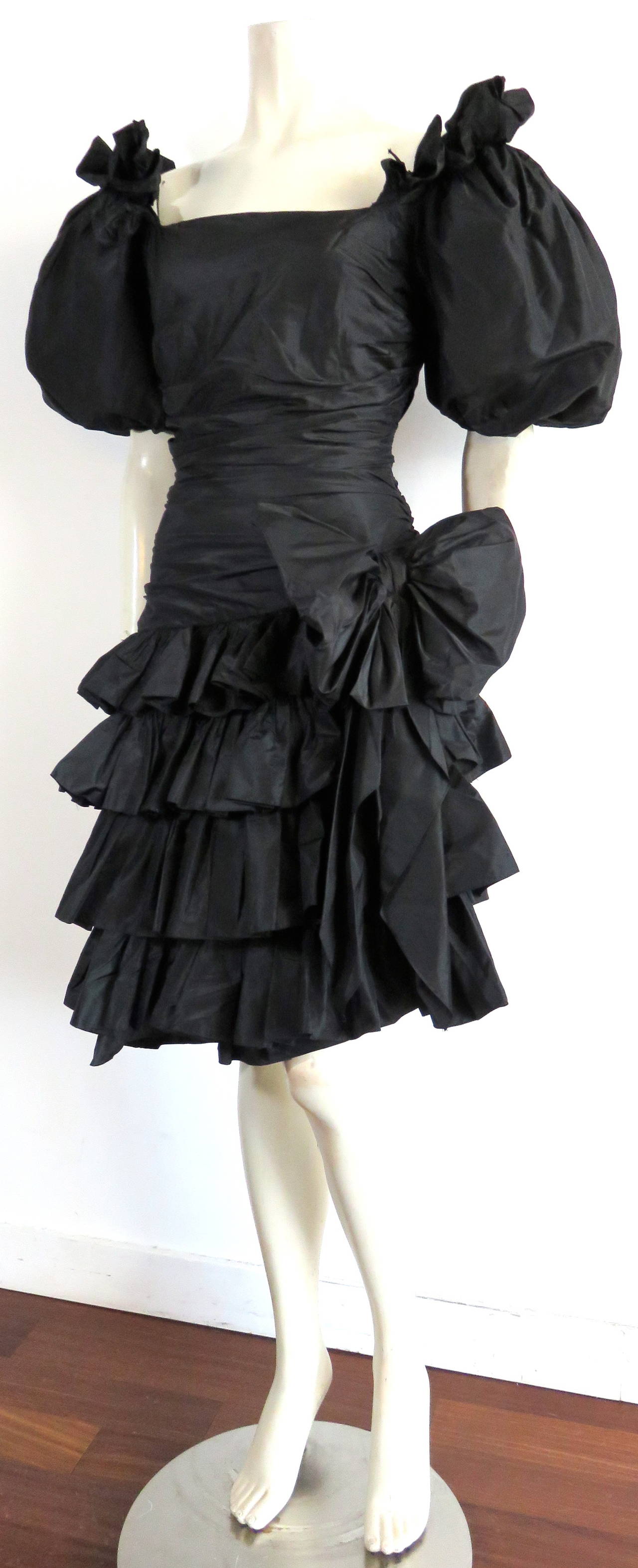 1980's OSCAR DE LA RENTA Flamenco inspired, silk taffeta evening dress.

Crisp, silk taffeta fabrication.

Oversized, 'balloon' style short sleeves with side, ruffled neckline detail.

Flamenco-style, angled bottom hem-line of dress with