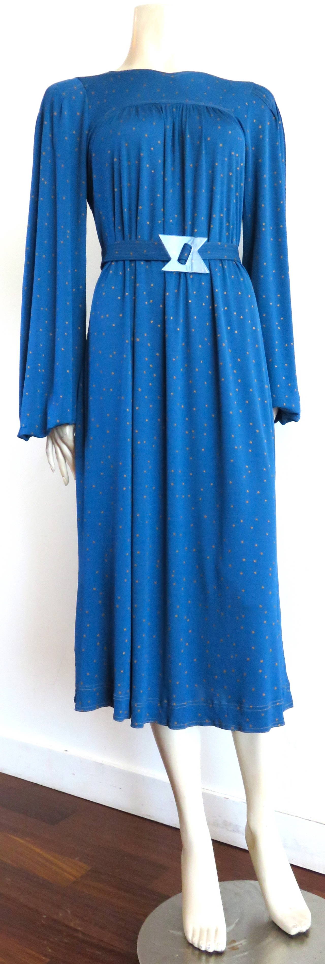 1970's JEAN MUIR Belted dress with major, living, fashion designer provenance (provided upon request)

This lovely dress is made of a gorgeous, cerulean blue, viscose, matte-jersey with golden dot overprint. 

The dress features an adjustable,