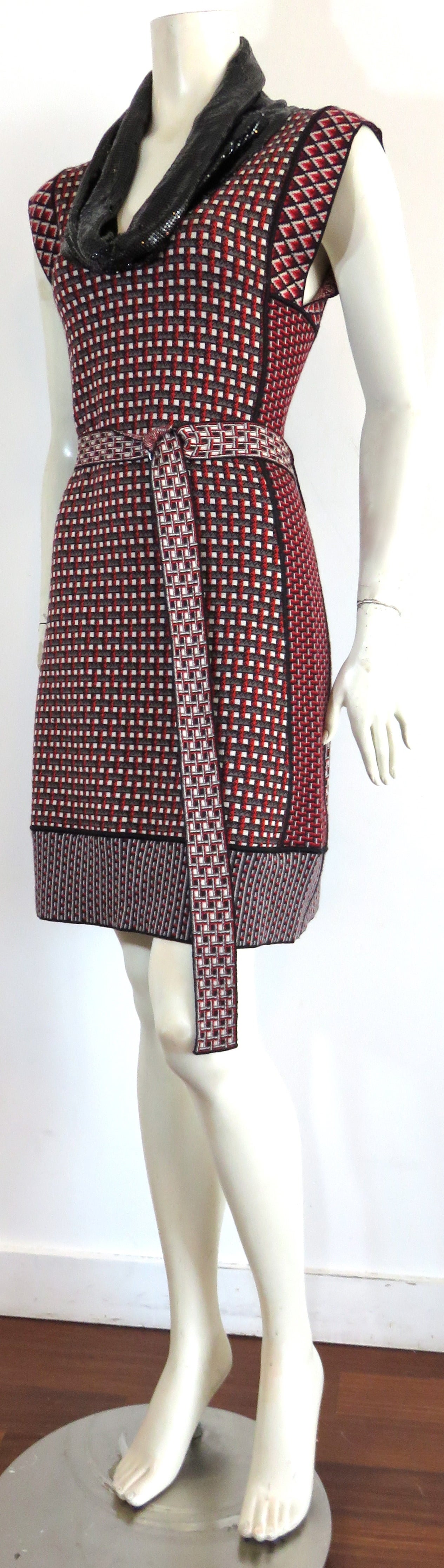 Worn once, JEAN-PAUL GAULTIER sweater dress with matching, adjustable belt.

Glistening, black metal mesh cowl neck collar detail.

Multi-color, geometric neat sweater patterning with contrast paneling.

Signature locker-loop at