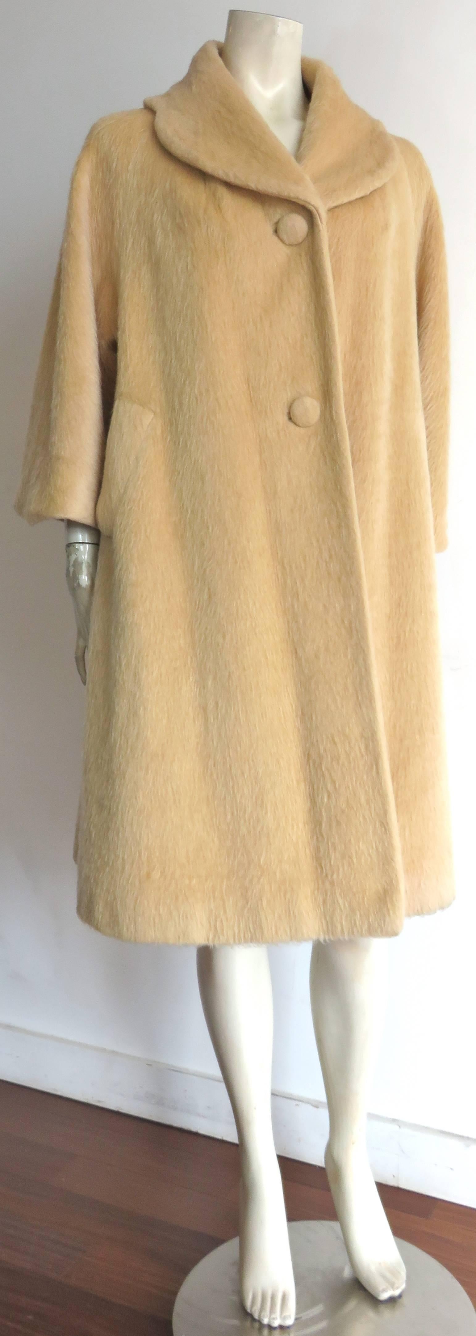 Lovely, 1960's LILLI ANN, plush mohair wool coat in apricot tone, beige color.

Self-fabric covered buttons at front opening.

Twin pockets at the sides.

'A'-line silhouette, with curved collar shape.

*MEASUREMENTS*

There is no size