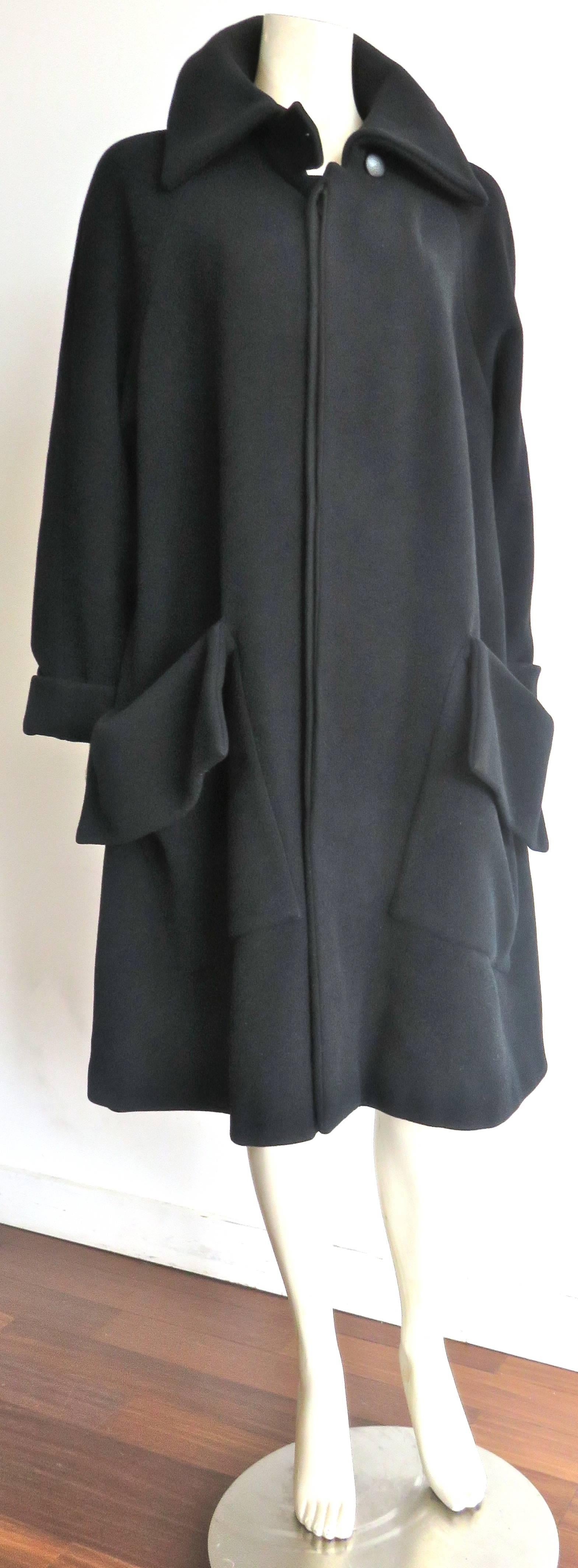 Gorgeous, 1990's YOHJI YAMAMOTO Black wool flap detail coat.

Oversized, loose fit silhouette with exaggerated flap detail pockets at the front waist.

Concealed, button front placket opening.

Large shape collar.

Made in Japan, as