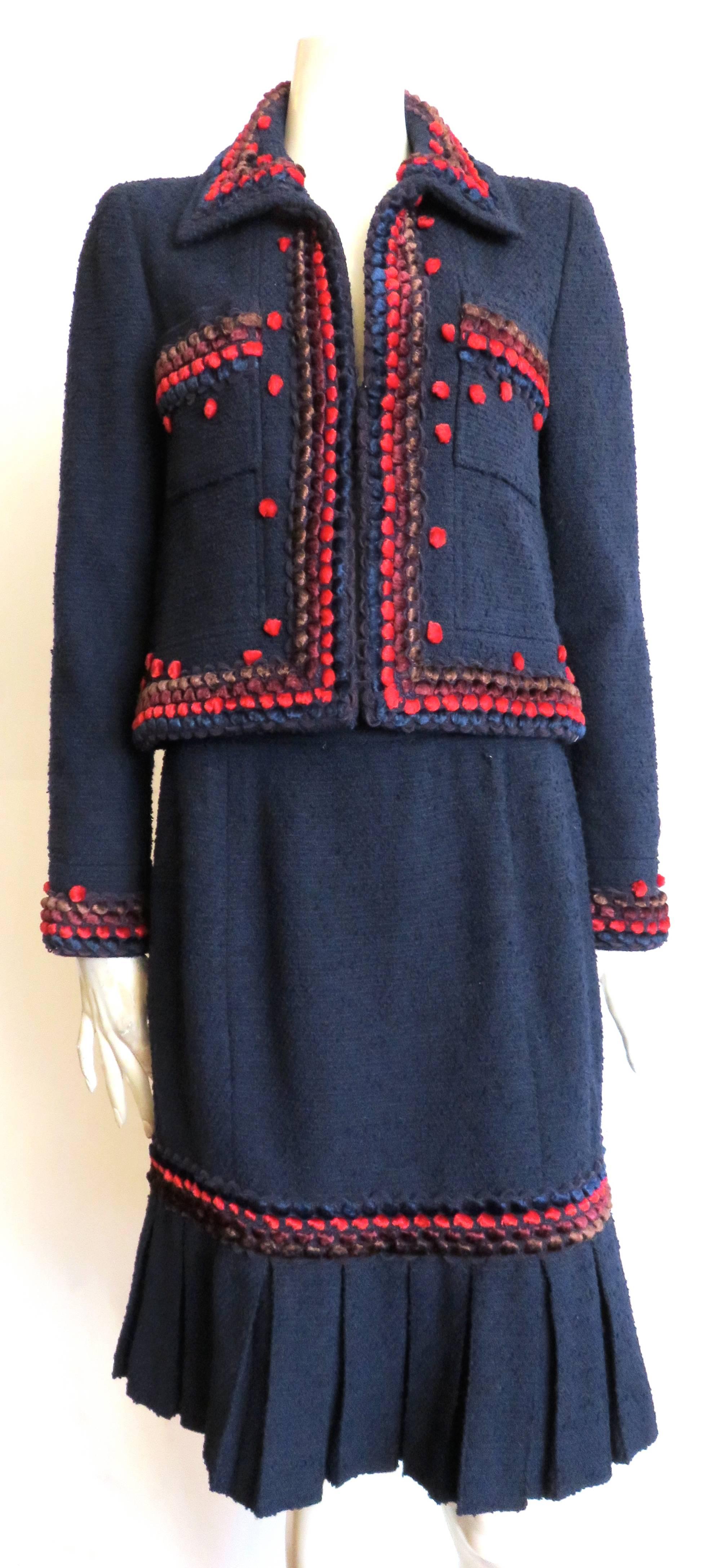 Great condition, CHANEL PARIS, Chenille pom-detail, wool bouclé, 3pc. skirt, or pant suit set.

This amazing set includes one jacket, one matching skirt, and one matching pant.

Dark, night-blue, wool bouclé base cloth fabrication with velvety