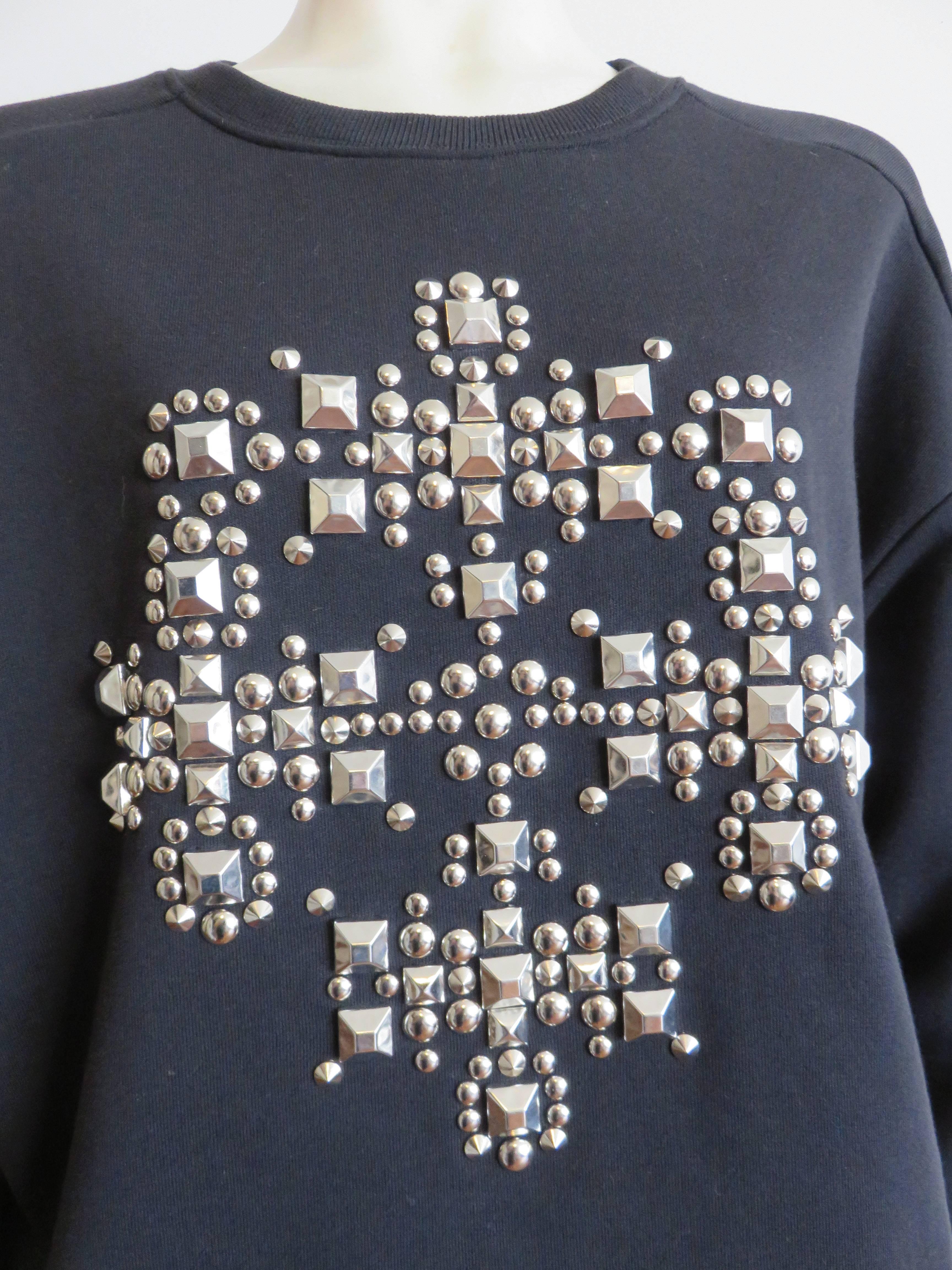 Worn once, 'like new' condition, Fall 2014 SAINT LAURENT PARIS by Hedi Slimane studded sweatshirt.

This amazing sweatshirt features polished metal, pyramid, cone, and stud nail heads in different sizes, composed in a cross shape