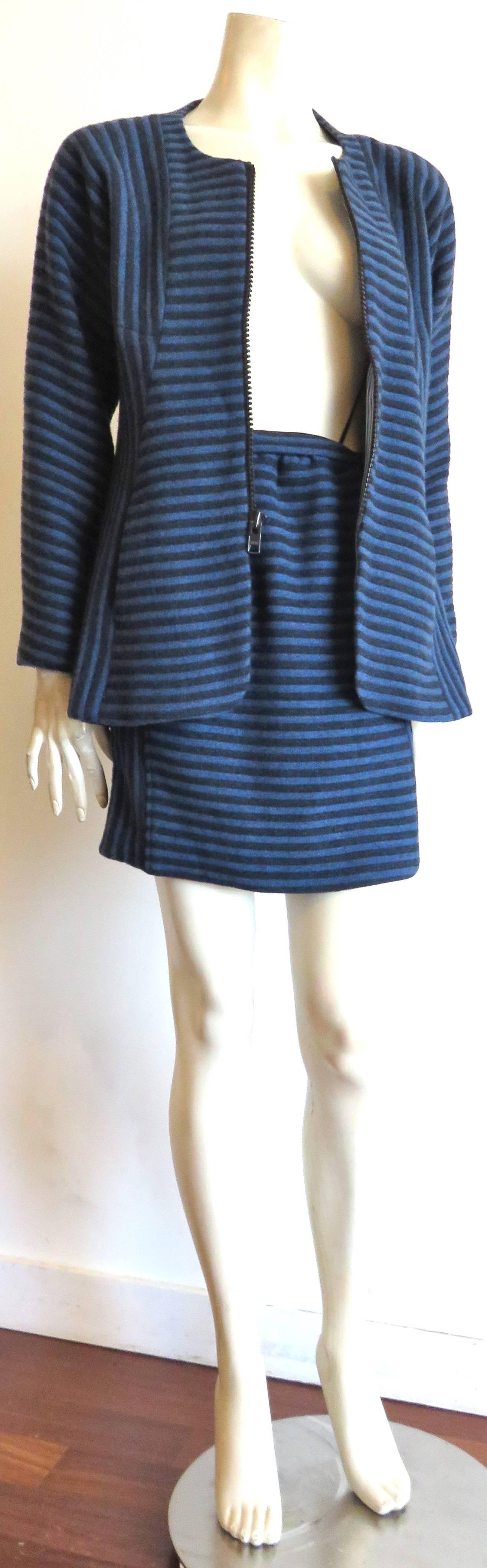 Mint condition, 1995, GEOFFREY BEENE, blue and dark midnight striped wool, mini-skirt suit set.

Gorgeous, seam paneling with contrast directional stripe technique.

Zipper front opening with curved front hem.

Raglan sleeve construction at