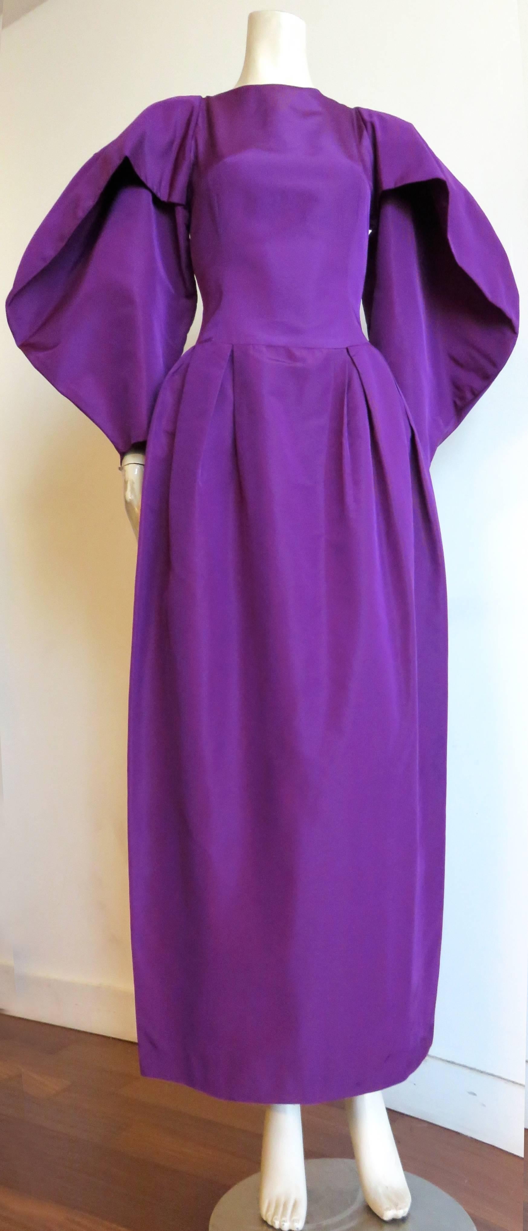 Excellent condition, 1980's CHLOE, by Karl Lagerfeld, silk evening dress.

This amazing dress features exaggerated, circle-shaped, wing sleeves with draped, fold detail at the front.  

Crisp, taffeta weight, pure, silk faille, woven fabrication