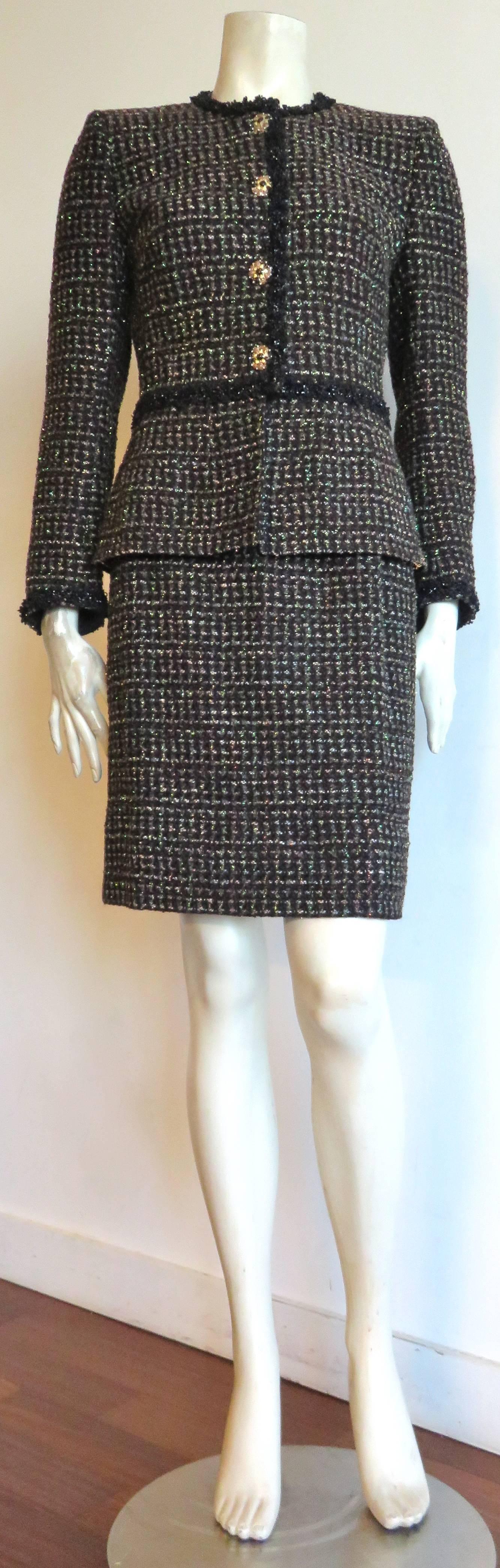Excellent condition, 1980's CHANEL BOUTIQUE Metallic tweed evening skirt suit.

Luxurious woven tweed fabrication in black ground with dark brown, oatmeal, and metallic gold woven pattern.  Solid black wool, and shiny Lurex border trim