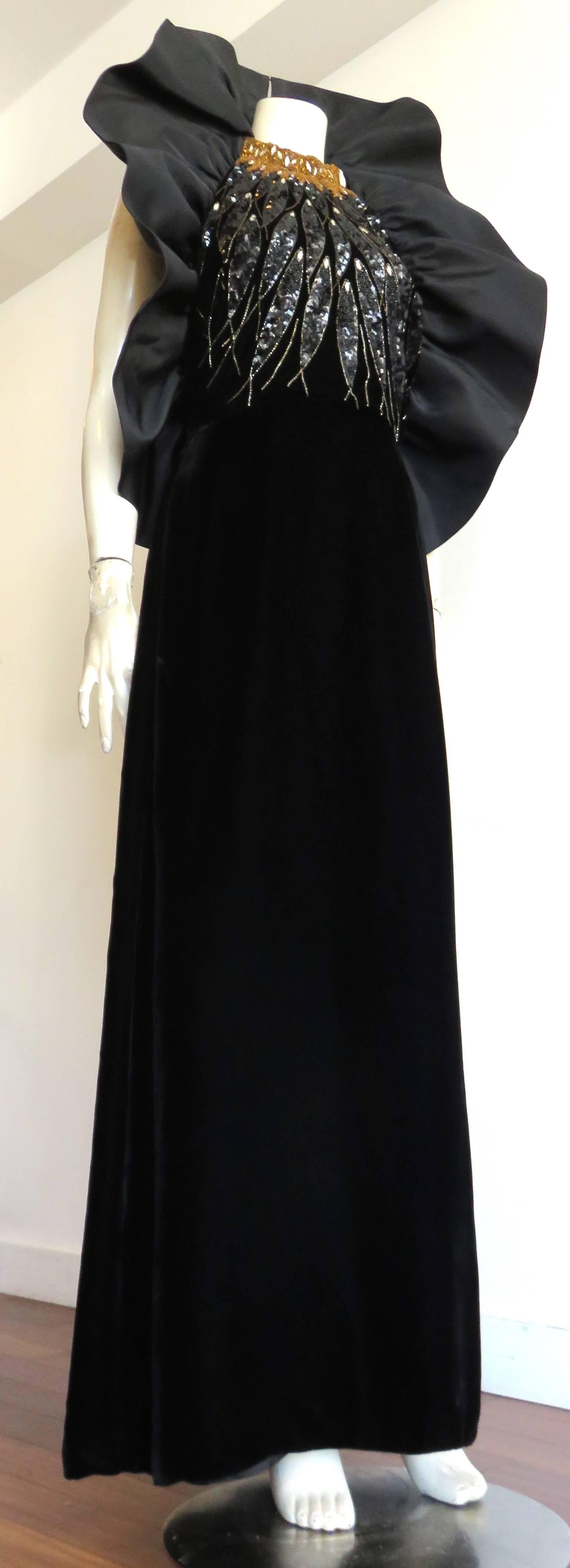 Excellent condition, 1980's, PAUL-LOUIS ORRIER, embellished, silk velvet evening gown.

This extraordinary evening gown is made of ultra-soft, black, silk, velvet with hand-beading, and sequined artwork on the front torso bodice.  

The