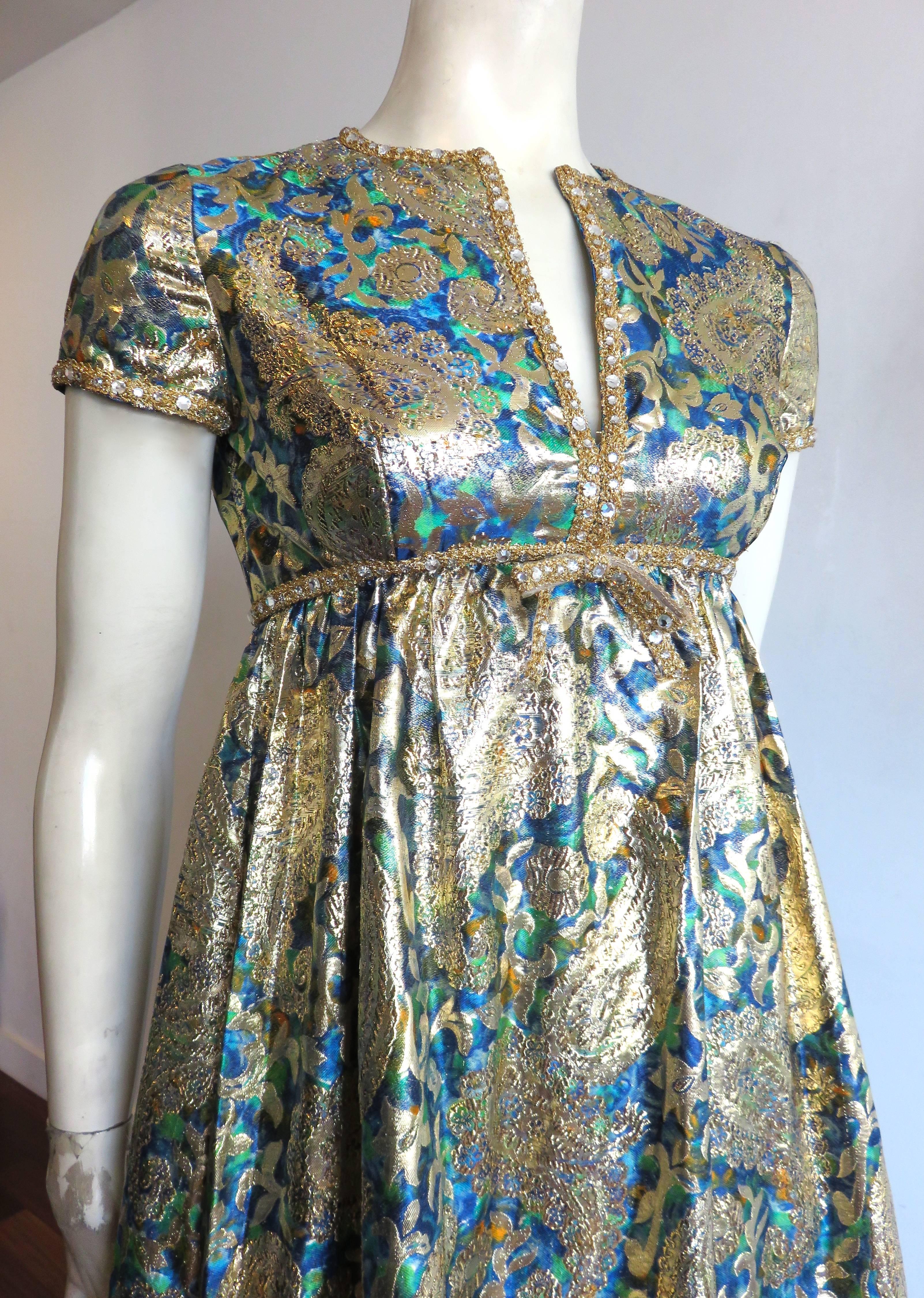 Pristine condition, late 1960's, Colinda by MALCOLM STARR, golden brocade evening gown.

This stunning evening gown is made of a opulent, bright, metallic-gold brocade featuring a gorgeous, paisley, and floral jacquard woven artwork.  The base of