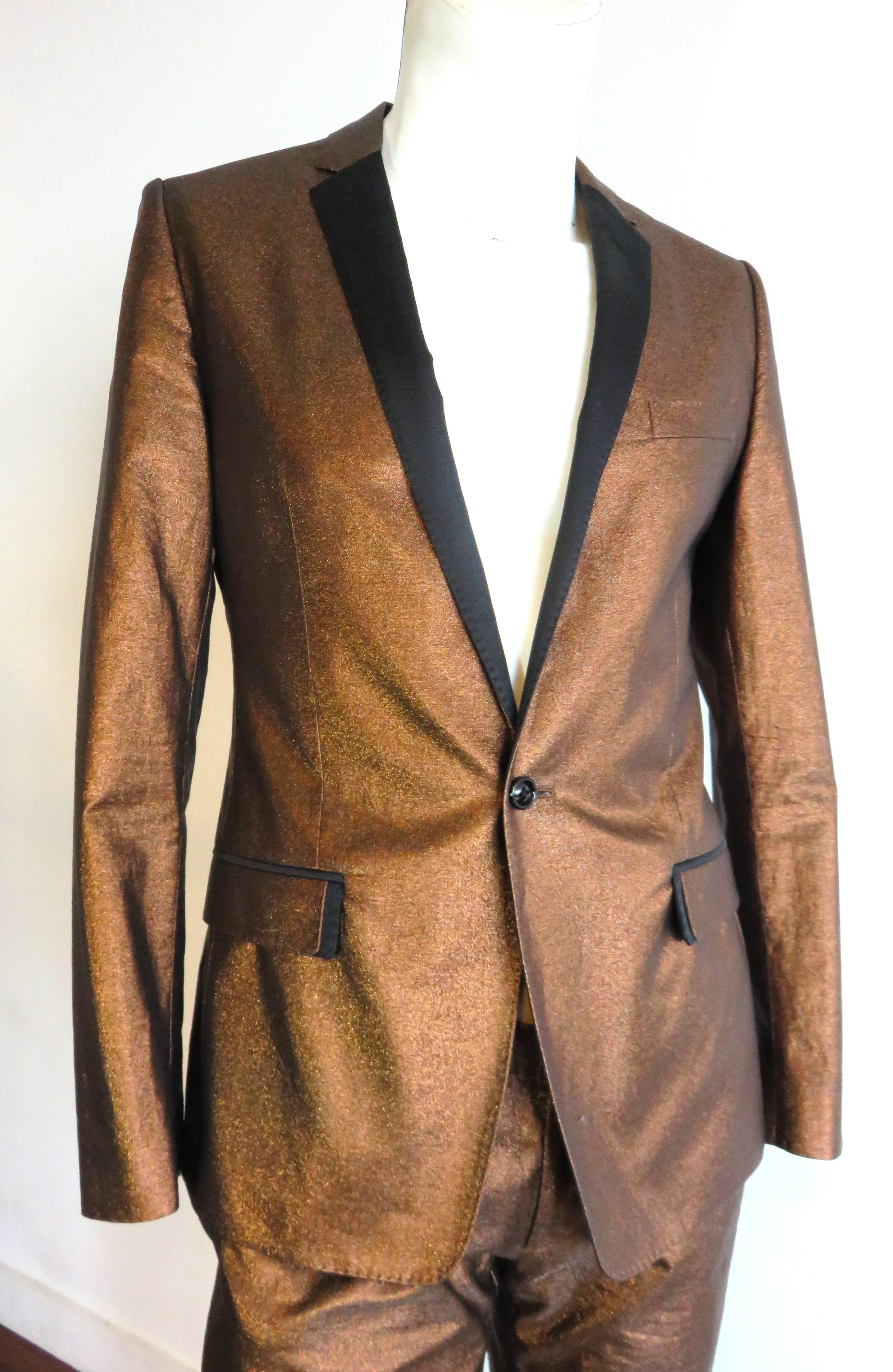 Worn once, 'like new' condition, DOLCE & GABBANA, men's, metallic bronze tuxedo.

Handsome tuxedo jacket and pant set in a 'shimmer' effect, metallic bronze fabrication.  

Contrast black twill lapels, front, double-flap, pocket detail, and side