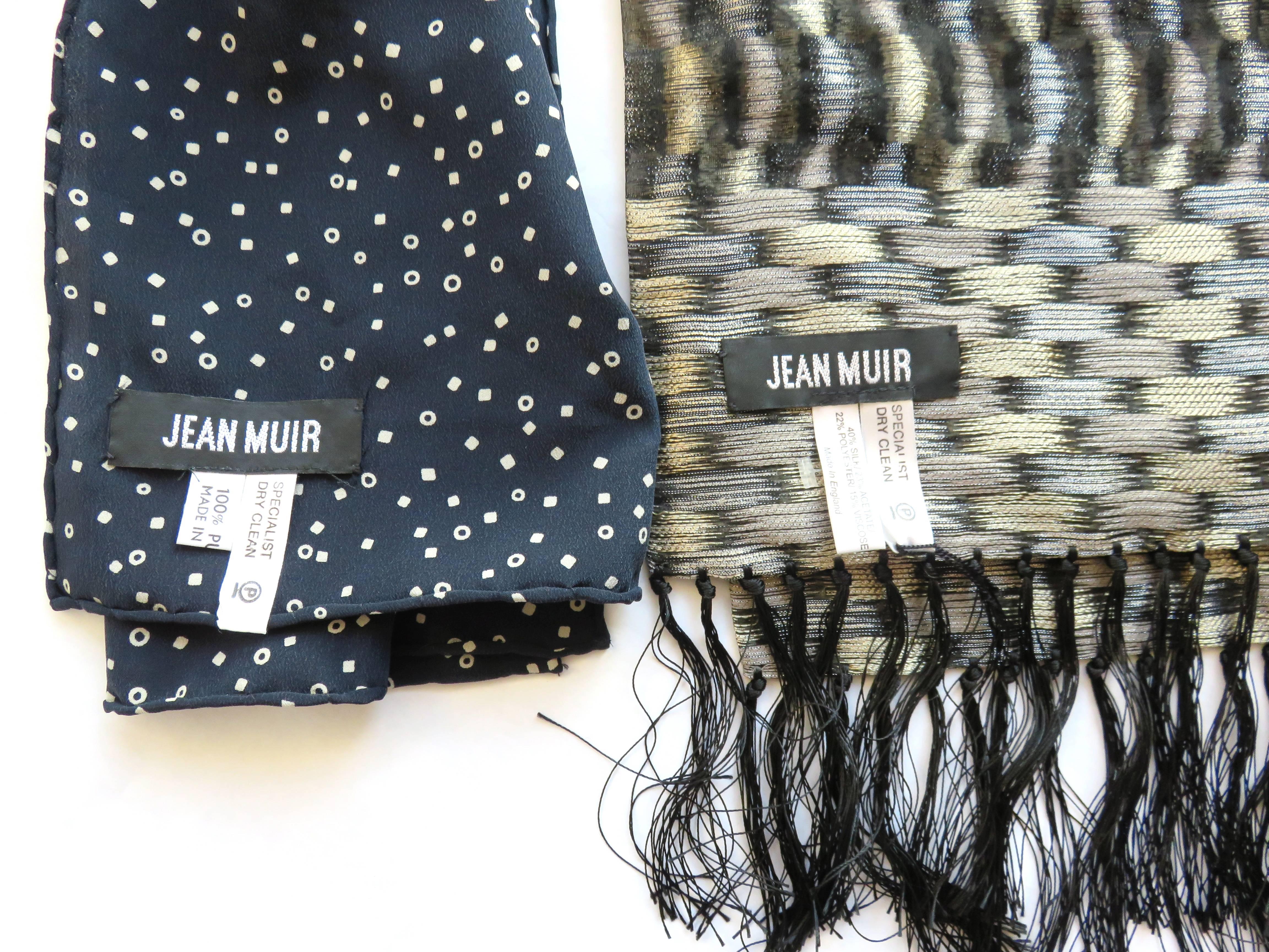 New, never used, 1970's, JEAN MUIR set of 2 silk & metallic scarves.

This sale includes two scarves, as photographed.

Scarf #1- 100% silk, dark midnight blue with nude pink, mini geometric print.  Hand rolled edges.

Scarf #2- Silk blend,