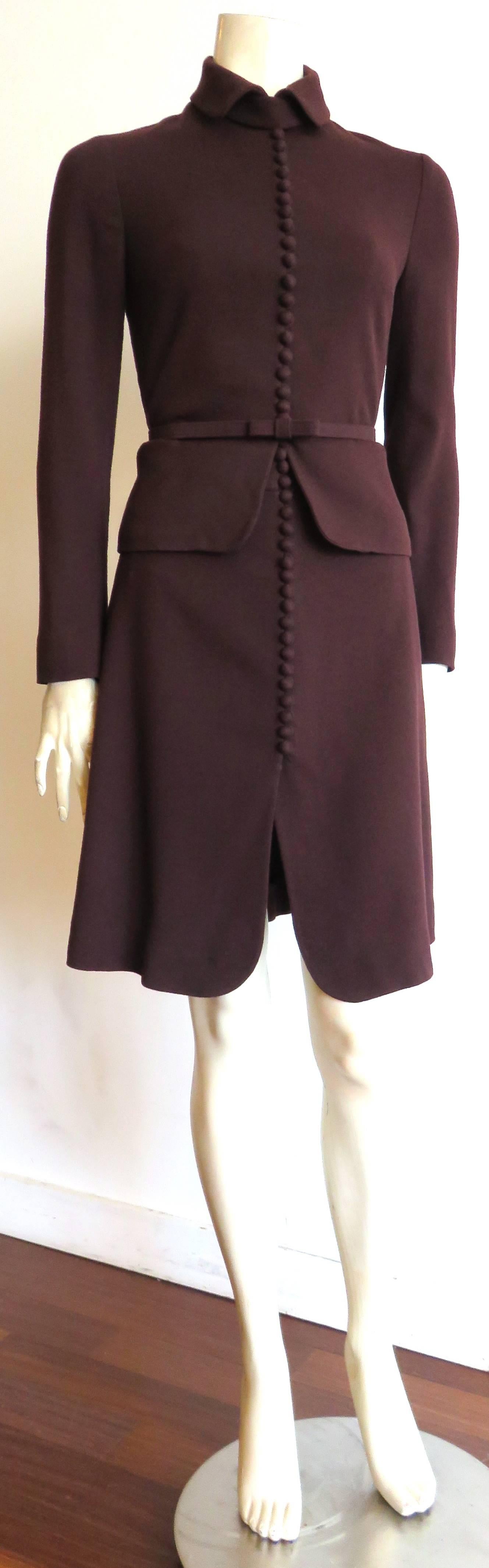 Excellent condition, VALENTINO, burgundy, wool crepe, button detail 2pc. skirt suit set.

The jacket features a victorian inspired, '20-buttons' front opening placket with neck, storm flap.

Matching, skinny, bow belt at the waist.

Skit
