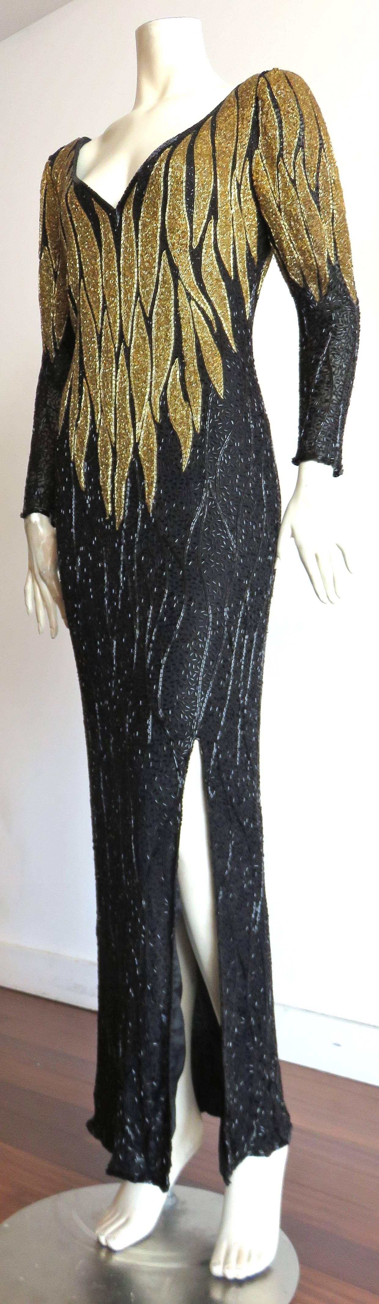 Excellent condition, BOB MACKIE, hand-beaded, gold-flame evening dress.

This dress is completely hand beaded rom top to bottom, with golden-flame detailing around the torso, and upper sleeves.

Jet-black, wavy, bugle-beaded ground atop silk