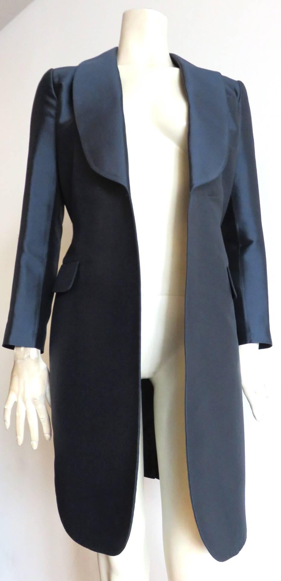 LOUIS VUITTON Silk satin evening coat with dress-style back.

This amazing coat features a menswear, tuxedo-inspired, shawl lapel at the front, and darted, dress-style waist with logo zipper the back.

Closure-less, open-front design at the