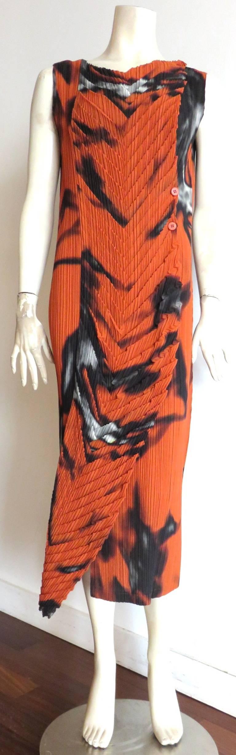 Worn once, 'like new' condition, ISSEY MIYAKE FETE pleated, flame print dress.

Gorgeous, mitered 'V' shape origami construction at the front with button opening at the wearer's left.

Side opening curves towards the front at the bottom