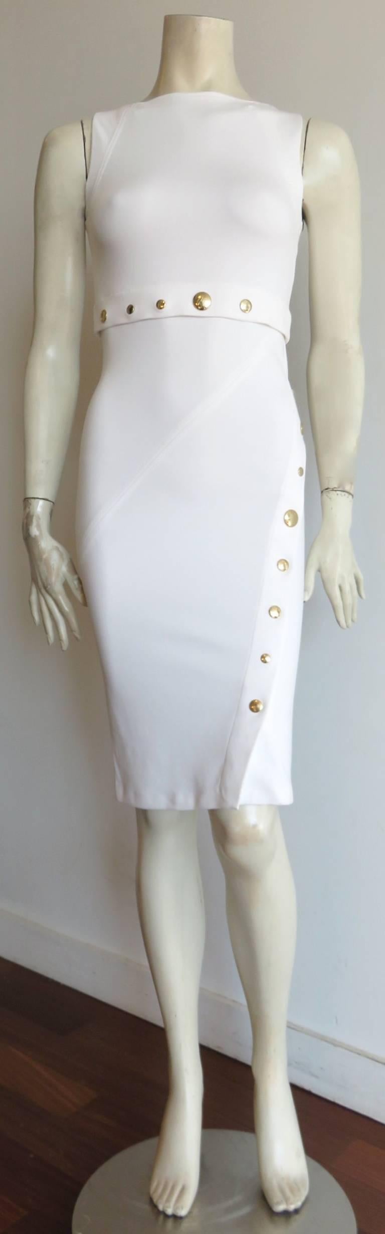 Recent, VERSACE COLLECTION, Medusa dome snap detail, white knit dress.

Optic white, knit jersey dress with gold-finished, Medusa engraved, metal snap heads at the waist, and side/front opening.

The snap heads at the side/front opening open,