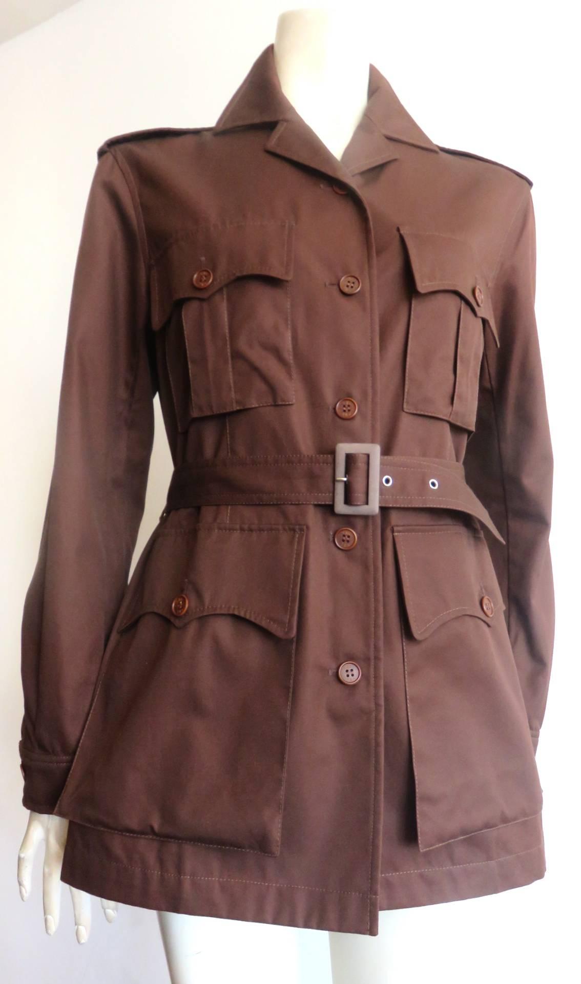 Excellent condition, 1998, YVES SAINT LAURENT Encore, cocoa-brown, coton twill, safari jacket.

Shaped pocket flaps with logo engraved button down closures at chest and waist.

Wide, button-down shoulder epaulet detailing.

Adjustable belted