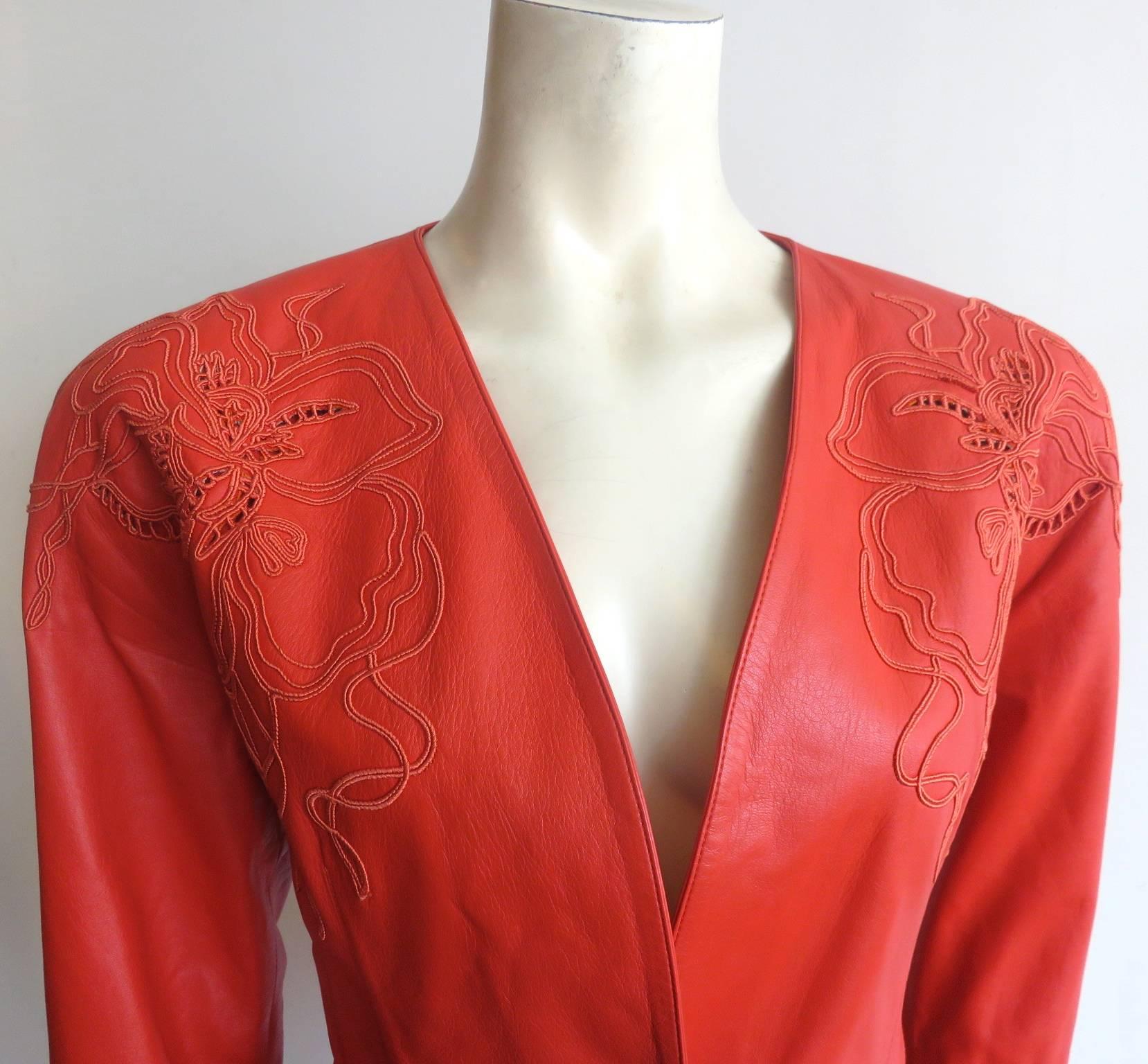 Never worn, 1980's LOEWE MADRID Embroidered lambskin leather skirt suit in lipstick red.

Gorgeous, floral, soutache embroidery detail at the shoulders and the bottom skirt with latter style stitch accent.

1980's, padded shoulders with a