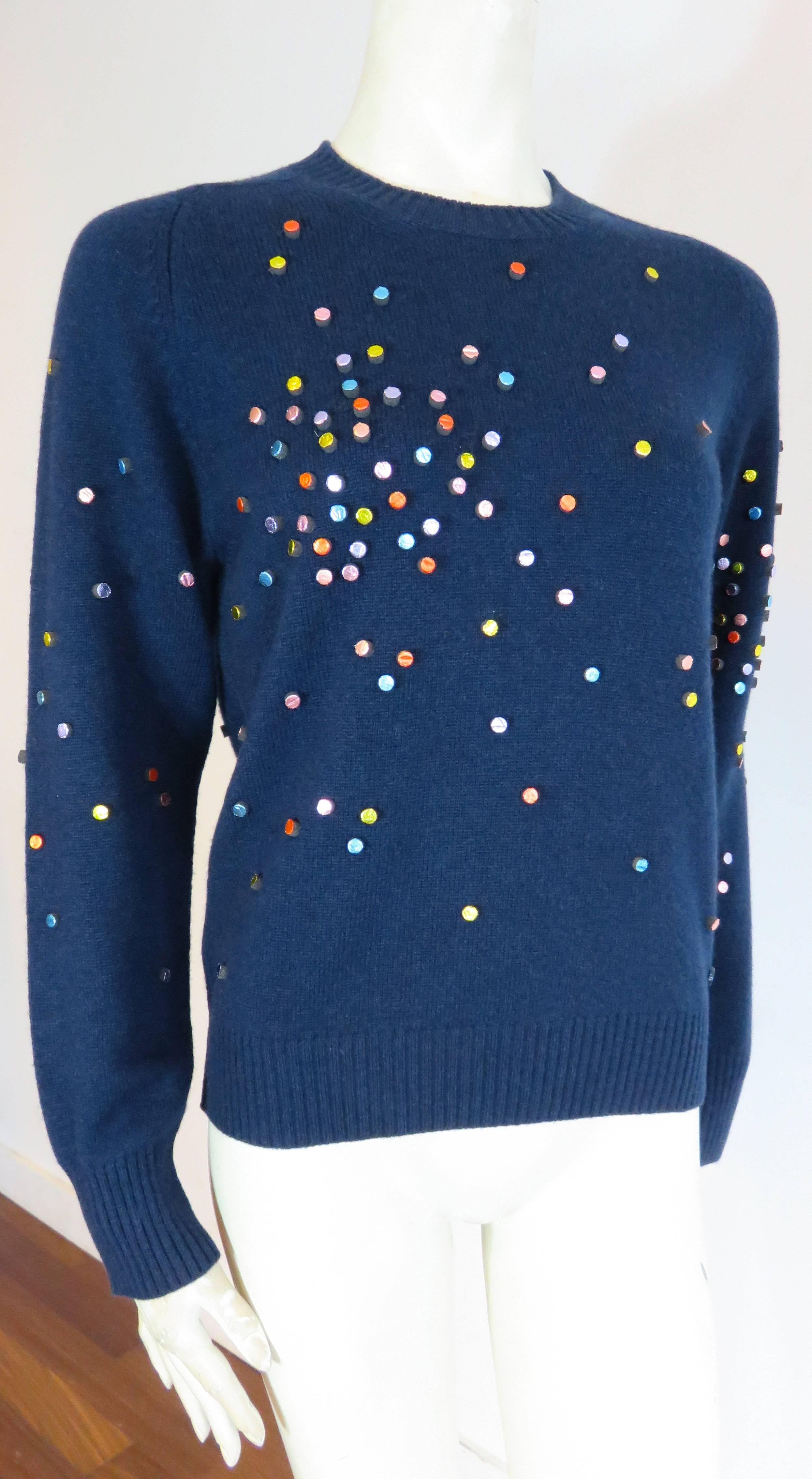 Excellent condition, CHANEL PARIS, 100% cashmere sweater with shimmering, multi-color, metallic foil covered, circle embellishments.

From the Fall 2014, 'SuperMarket / Un Grand Magasin' collection.

Luxuriously soft cashmere
