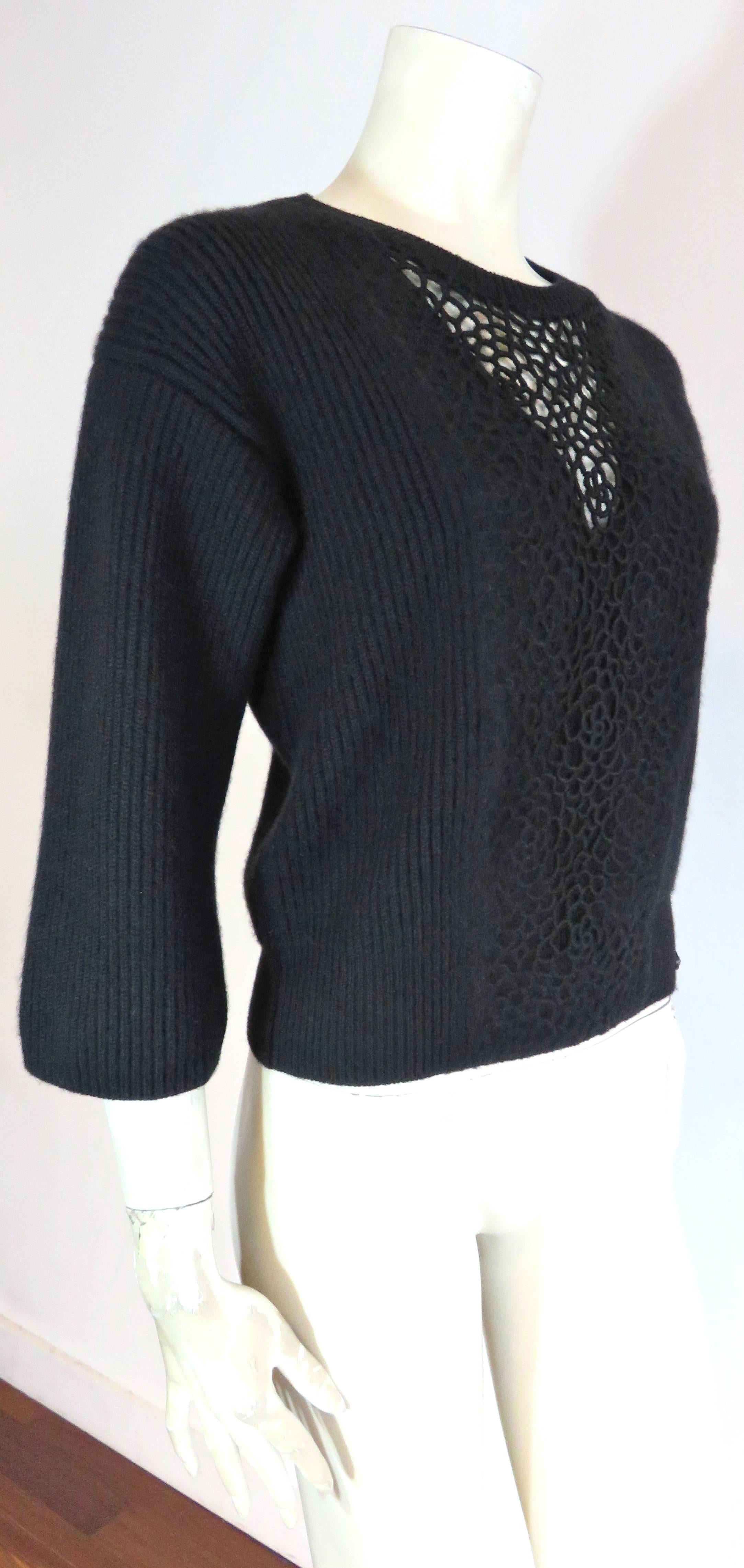 Worn once, excellent condition, CHANEL PARIS, embroidered Camellia cashmere sweater.

Luxurious, black sweater featuring embroidered Camellia lace work at front, with illusion detail at front 'V' neck.

Thick, rib-knit, 100% cashmere