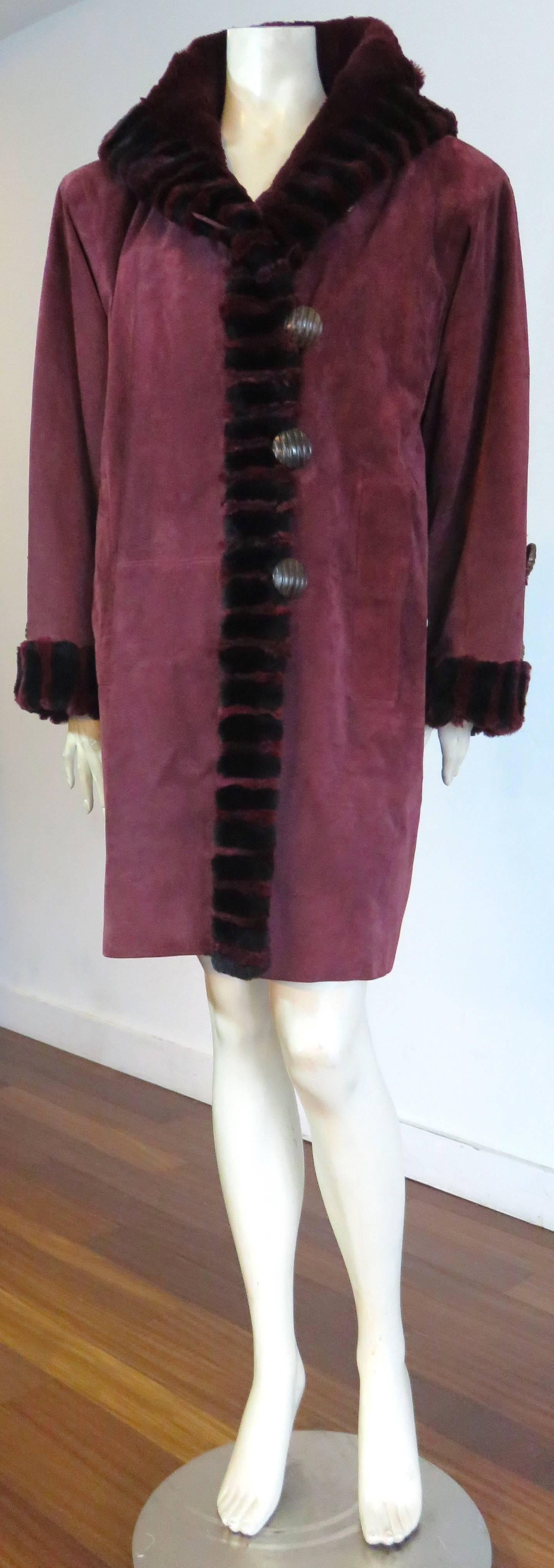 Excellent condition, 1980's YVES SAINT LAURENT FURS, suede skin & fur coat.

This luxurious coat is made of Bordeaux-colored, pig skin suede, and is fully lined in sheared beaver fur lining.

The coat features a gorgeous, seamed-in, striping