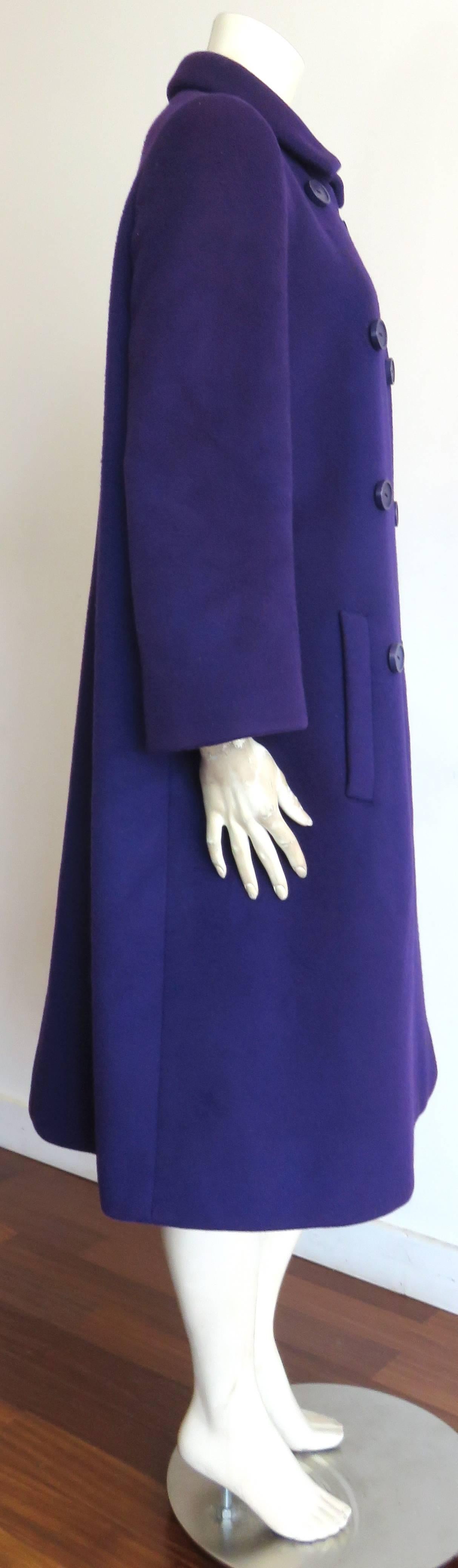 Wonderful, 1960's NORMAN NORELL wool coat featuring Norell's, classic, double-button front, clean-line silhouette.

Purple with blue-tone color, heavy-weight wool fabrication.

Oversized buttons at front.

Twin pockets at sides.

Fully lined