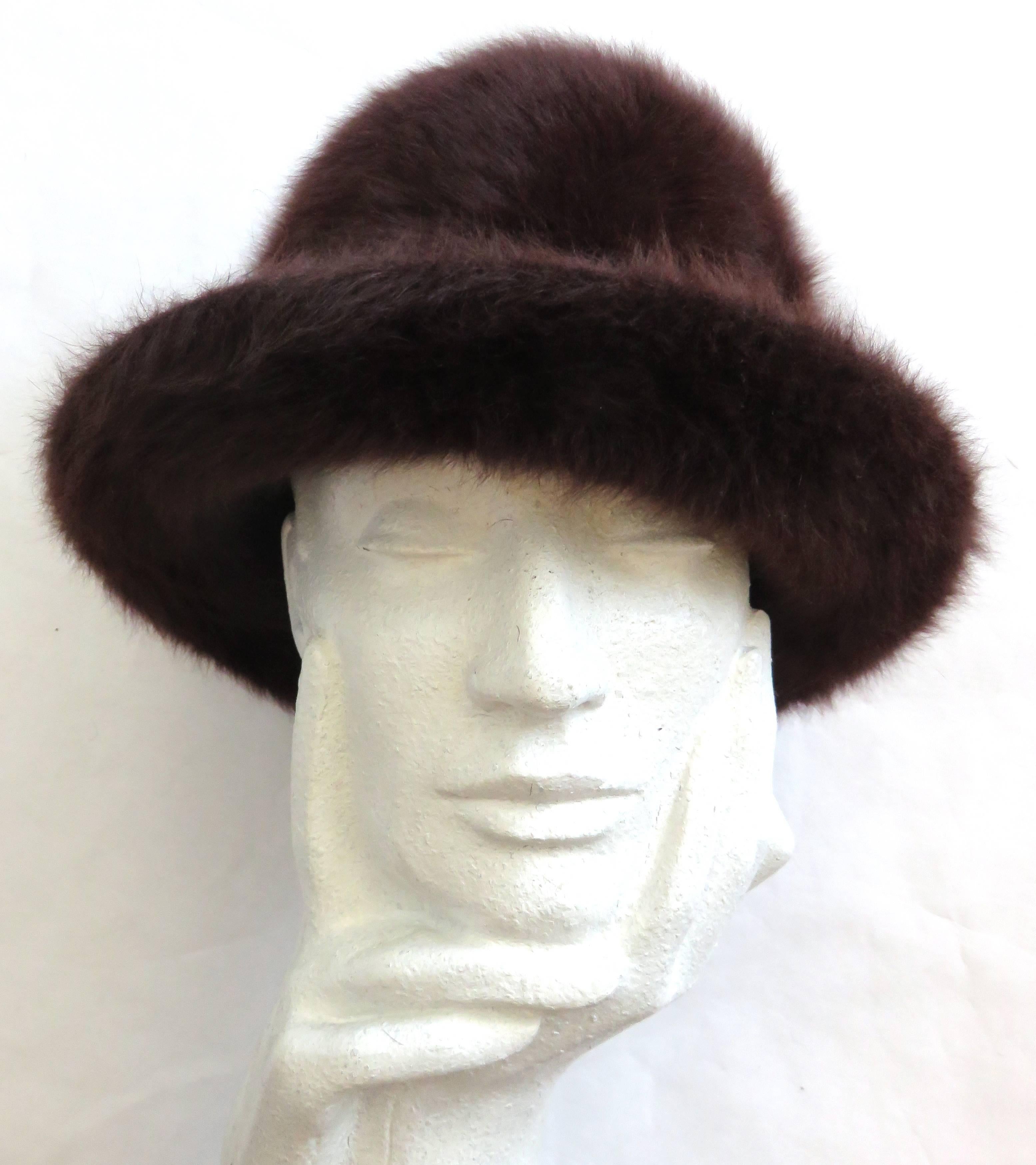 Worn once,'like new' condition, PHILIP TREACY, ultra-soft, and fluffy, mohair, bowler hat.

Soft, fur-like hand-feel in dark chocolate brown.

Metal unicorn logo charm at side.

Internal wire edge brim for shape.

Fully lined in logo